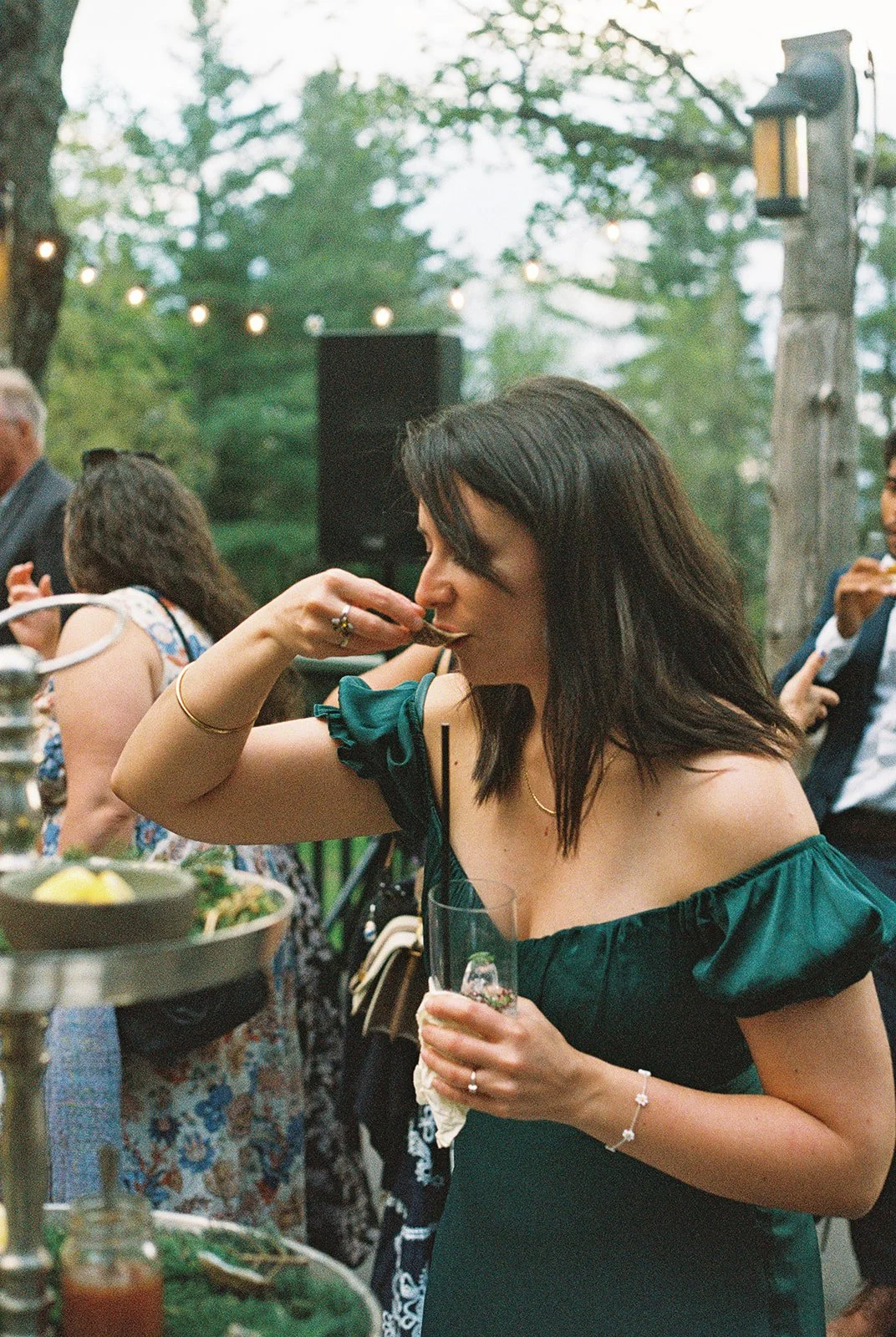 Guest eating an oyster during a cocktail hour at Deer Mountain Inn.