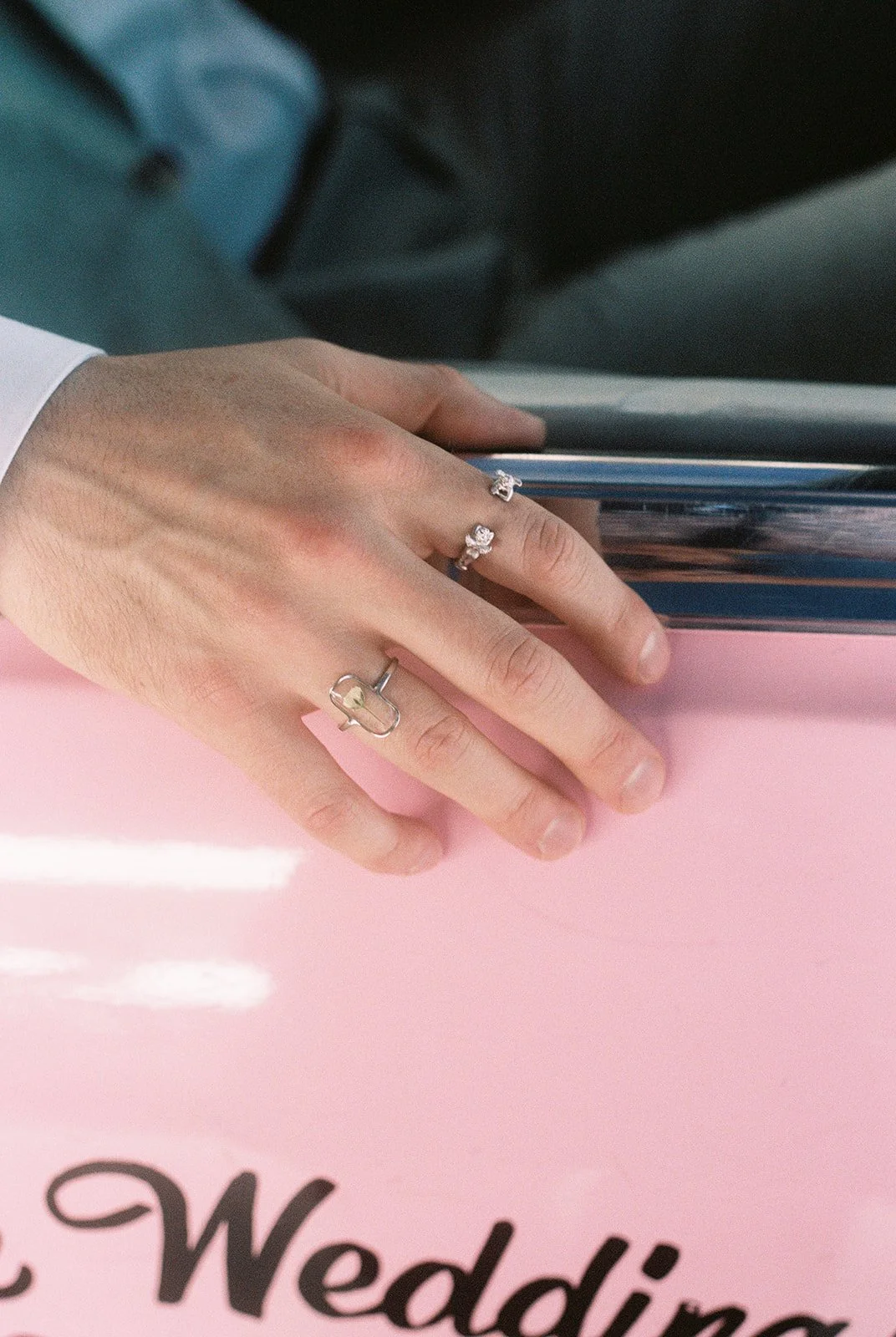 Close up shot of a grooms ring as hies sitting inside the Pink Cadillac at a Little White Wedding Chapel on 35mm film.