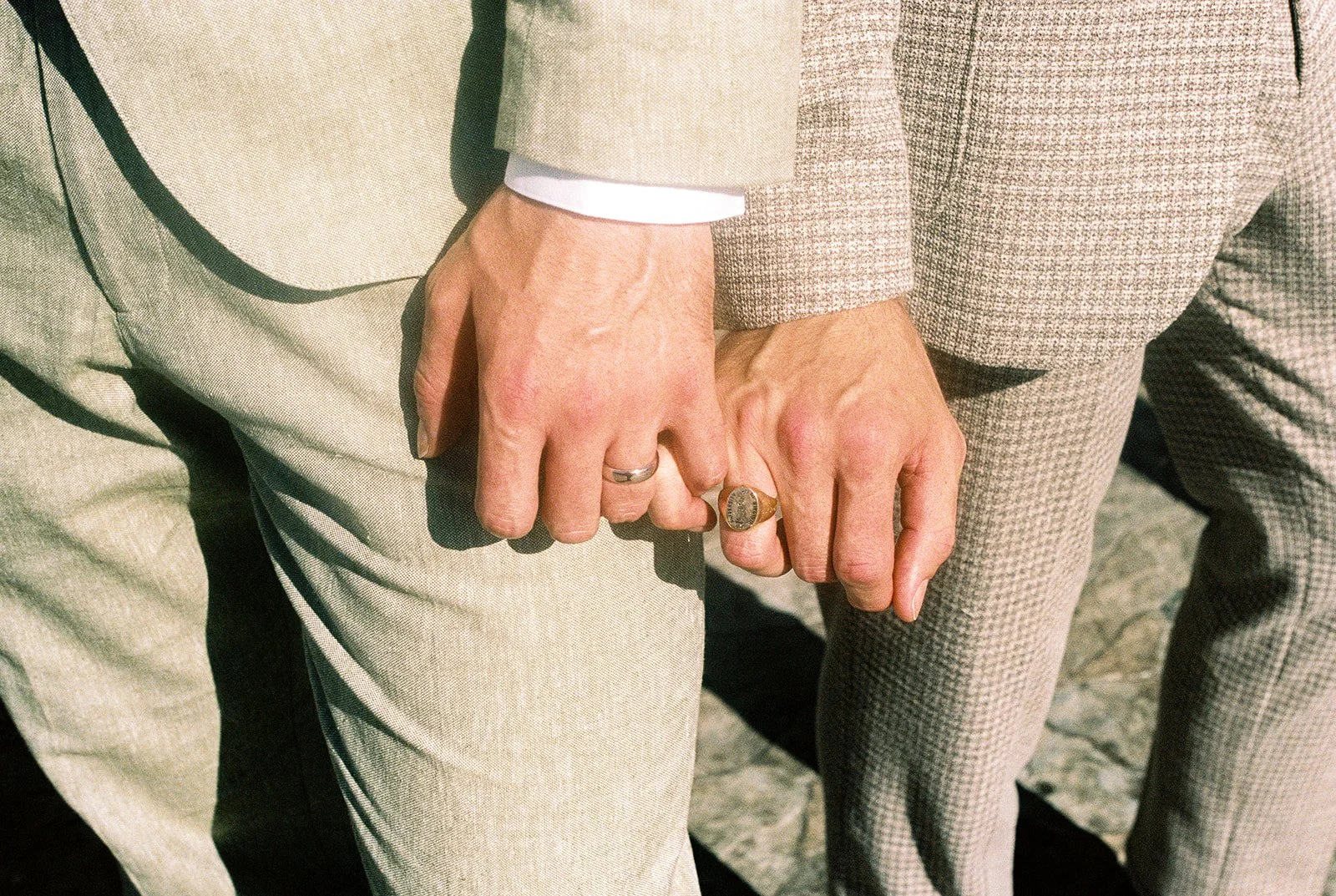 Close up shot of a couple holding pinkys.