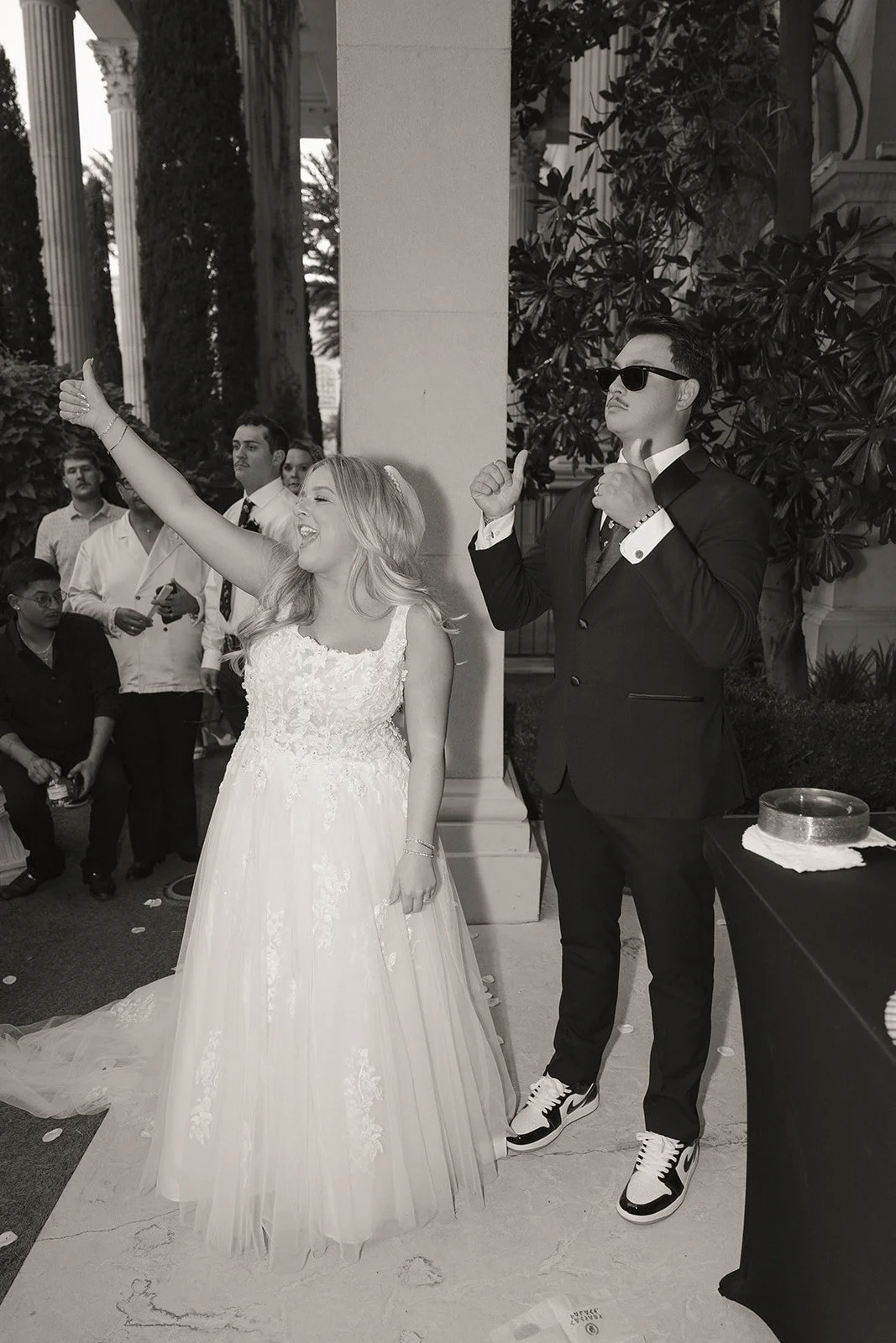 Bride and groom cheering during champagne toasts following their Caesars Palace Venus Garden wedding ceremony.