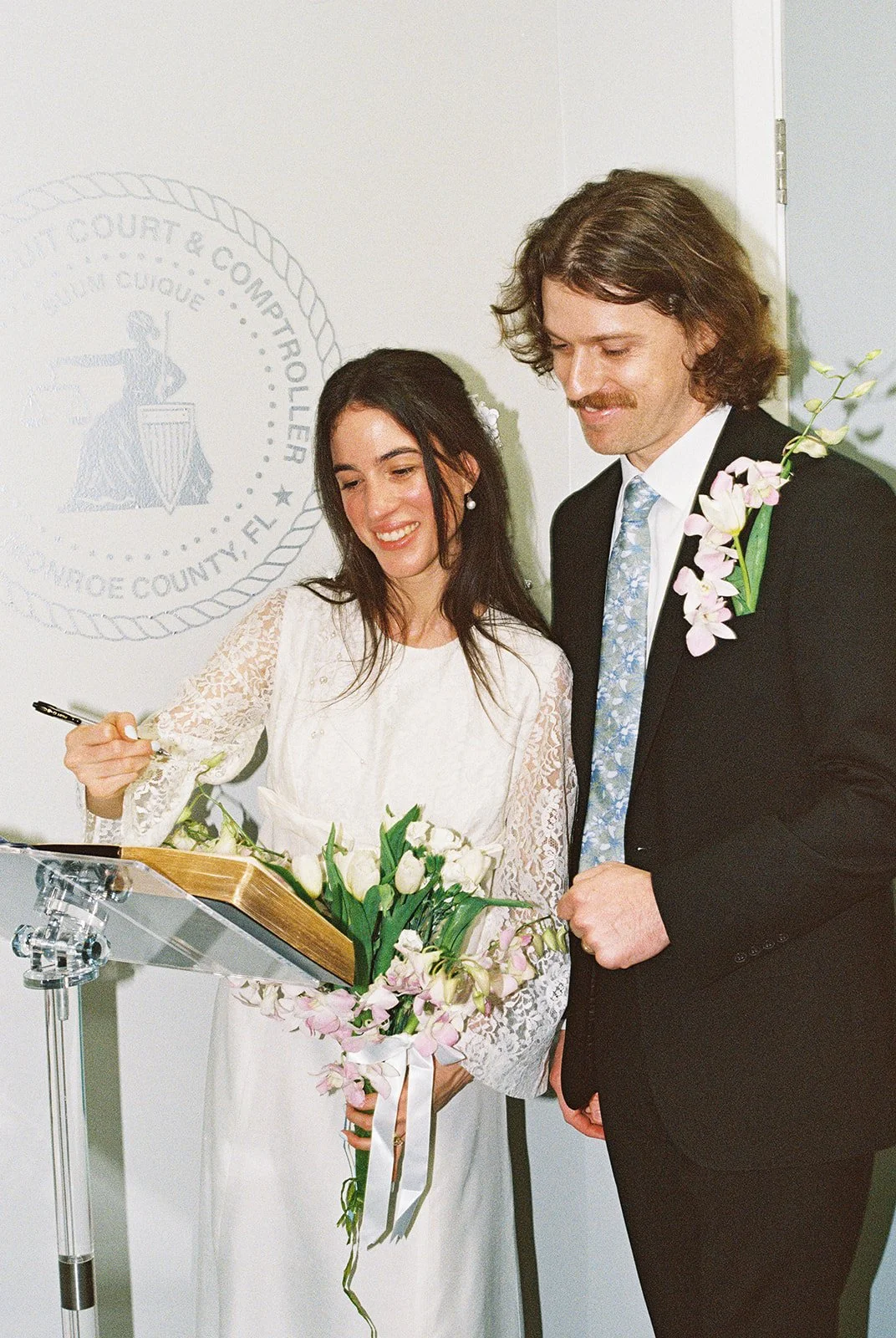 Couple signing their marriage license at Monroe County Courthouse in Key West, FL