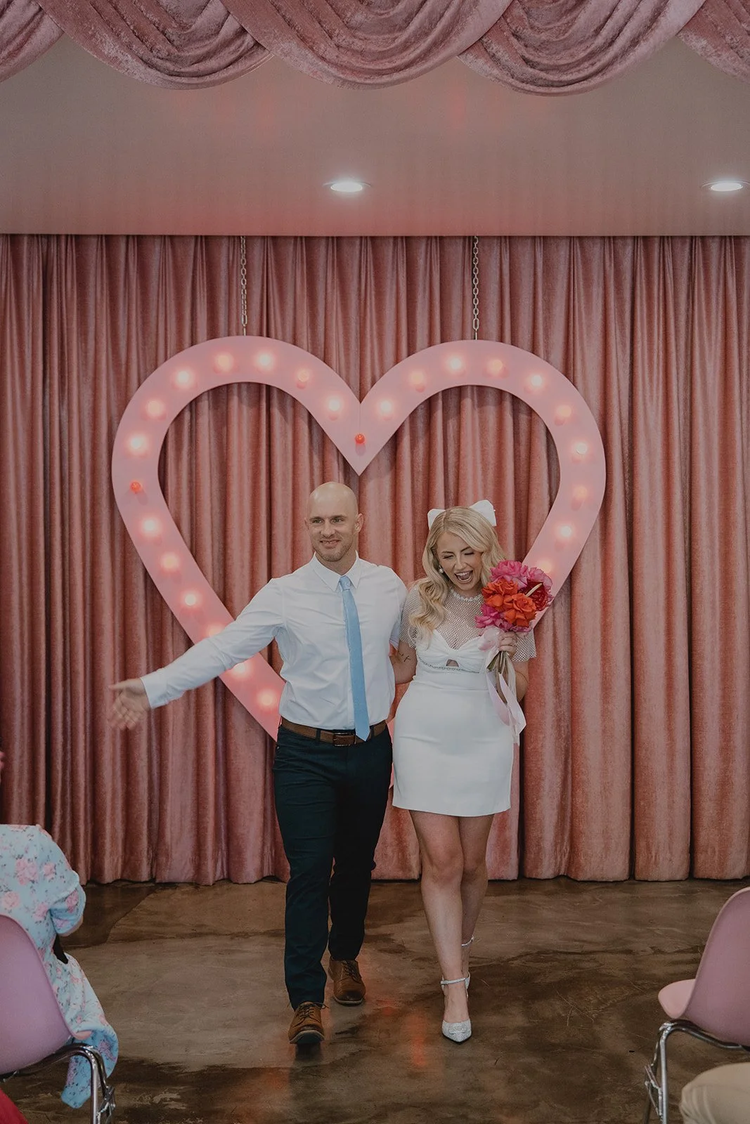 Bride and groom walking back down the aisle as husband and wife after their Sure Thing Chapel wedding ceremony.