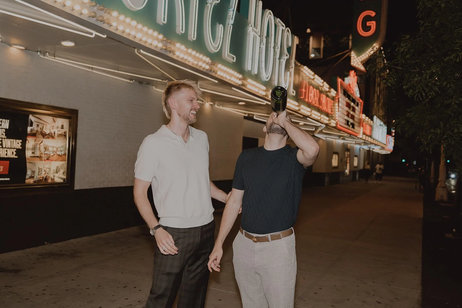 Man drinking champagne straight from the bottle during his Las Vegas Fremont Street elopement.