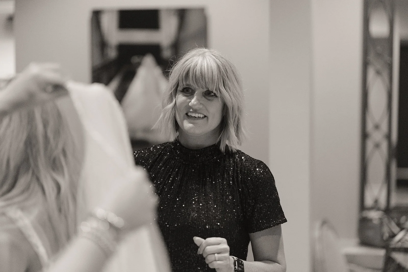 Candid black and white moment of the bride sharing a laugh during getting ready at Caesars Palace.