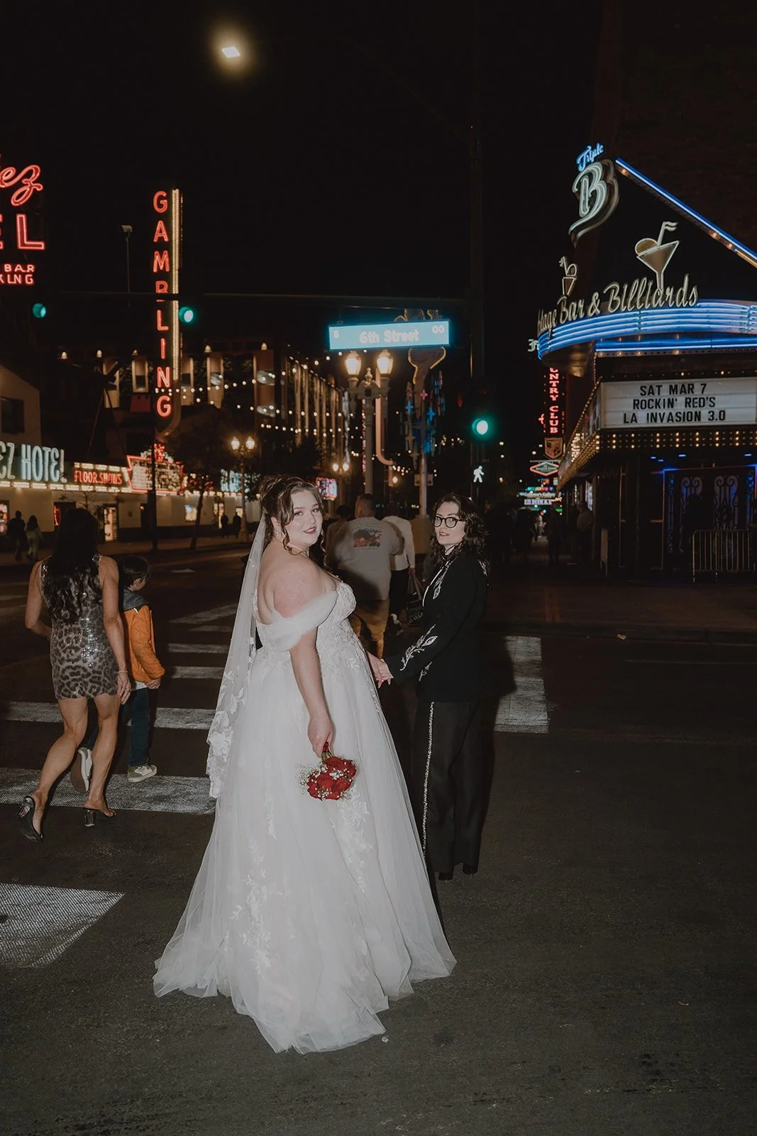 Couple walking across the street on Fremont in Las Vegas.