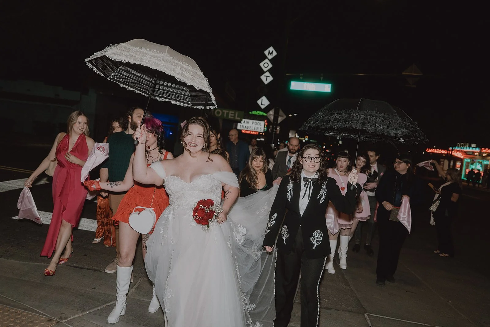 Couple walking down Fremont Street at night for their New Orleans style second line parade in Las Vegas.