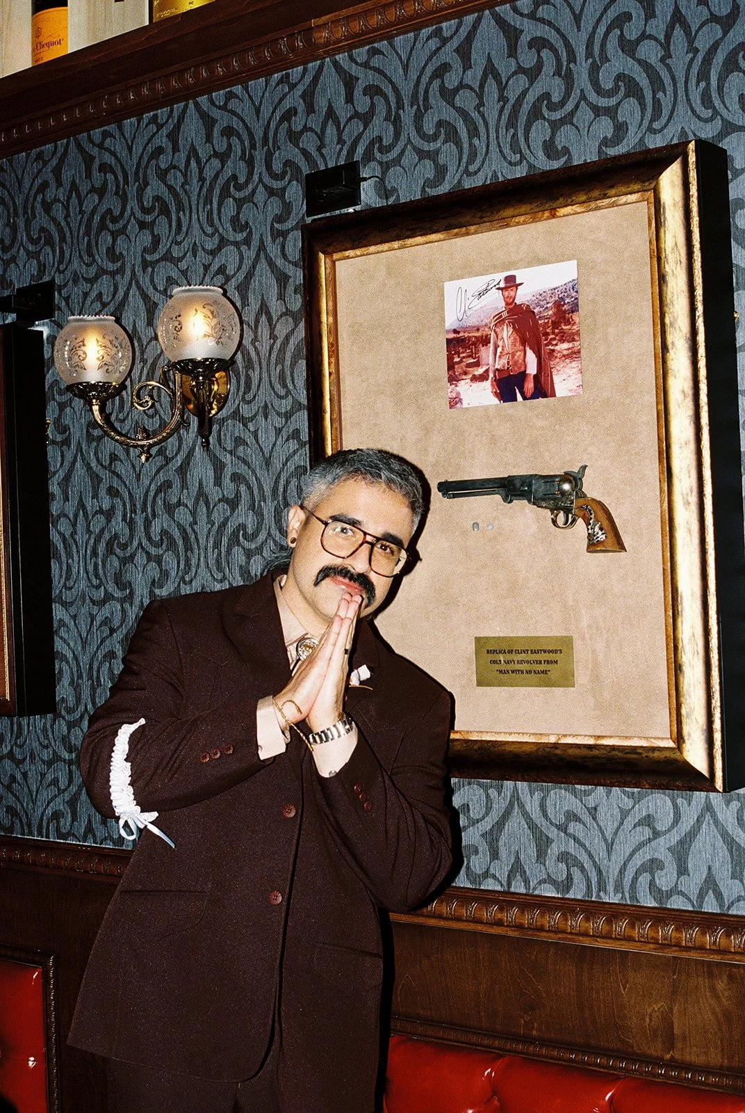 Groom posing in front of decor inside Golden Steer in Las Vegas.