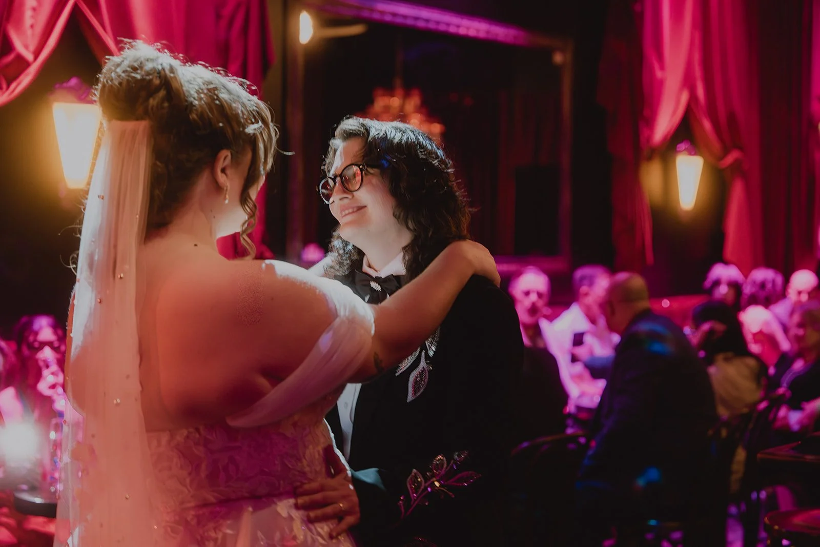 Couple sharing their first dance under pink lighting at Cheapshot in Las Vegas.