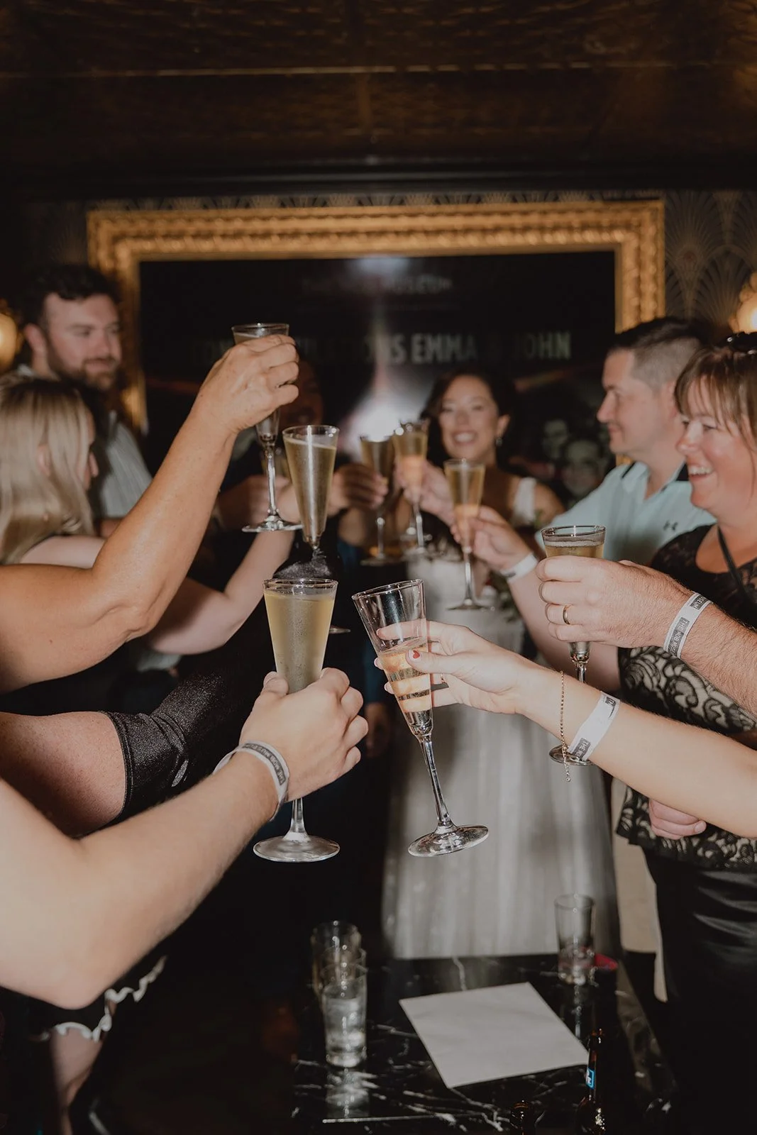 Bride, groom, and their guests toasting drinks after their Mob Museum wedding in Las  Vegas.