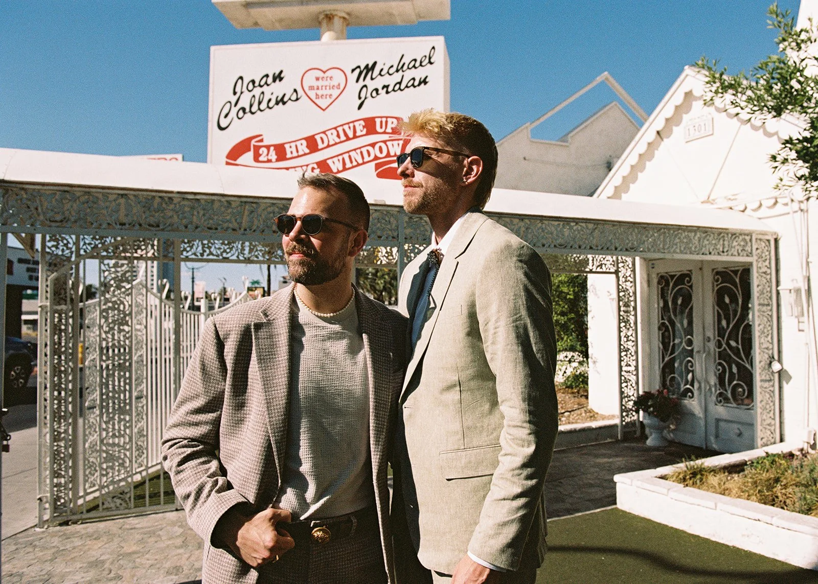 Couple posing in front of the Little White Wedding Chapel in Las Vegas on 35mm film.