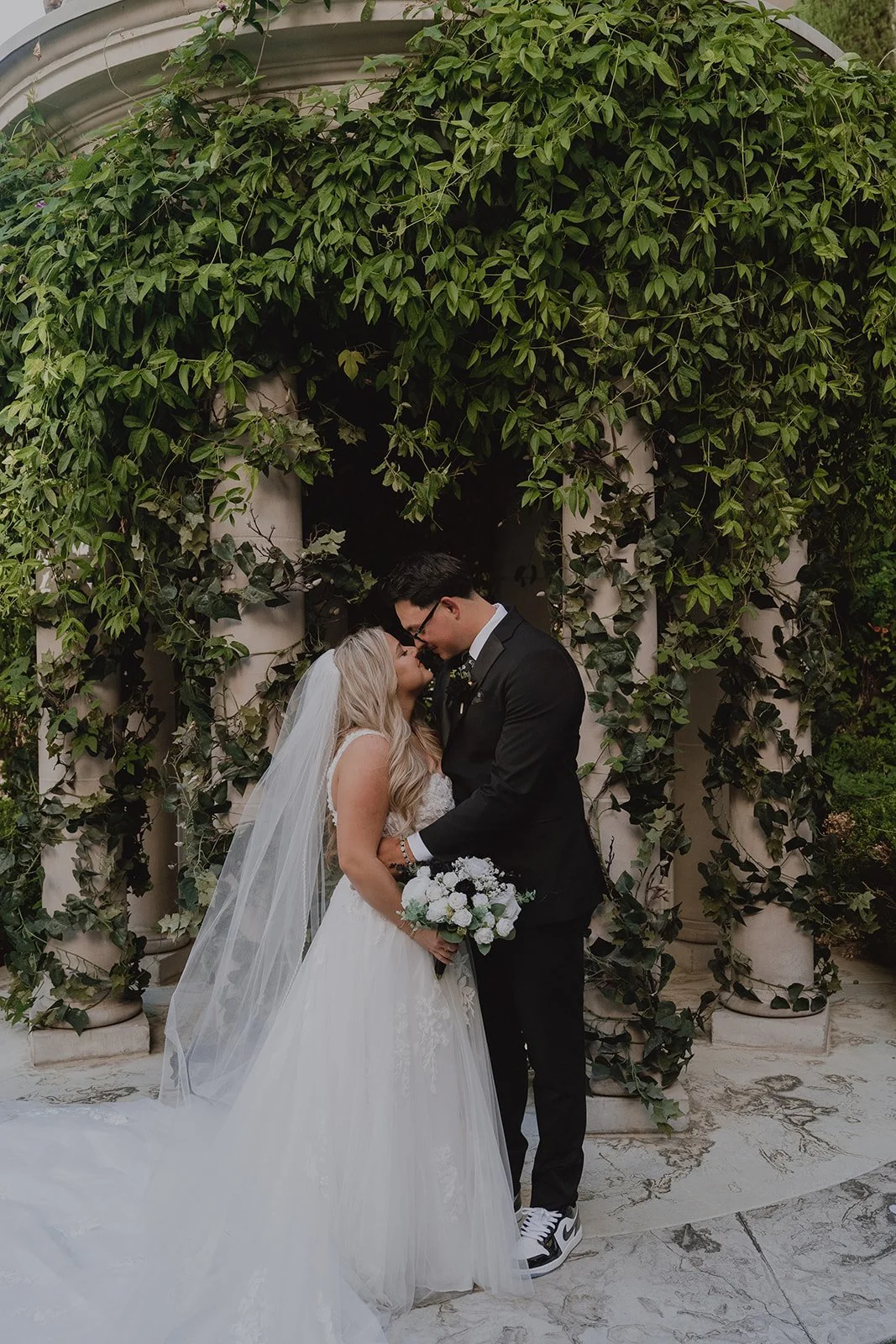 Bride and groom sharing a quiet moment during portraits at their Caesars Palace Venus Garden wedding.