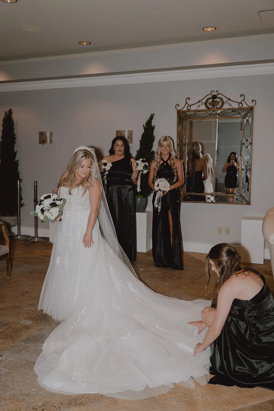 Bridesmaids helping adjust the bride’s dress during getting ready at Caesars Palace before the ceremony.