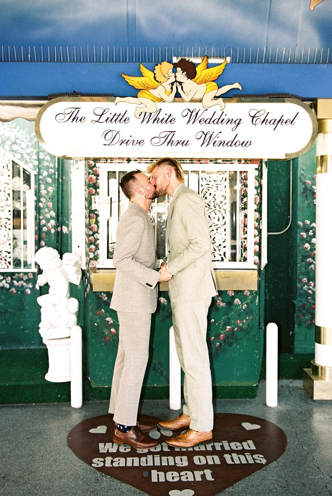 Couple sharing their first kiss as a newly married couple on 35mm film.