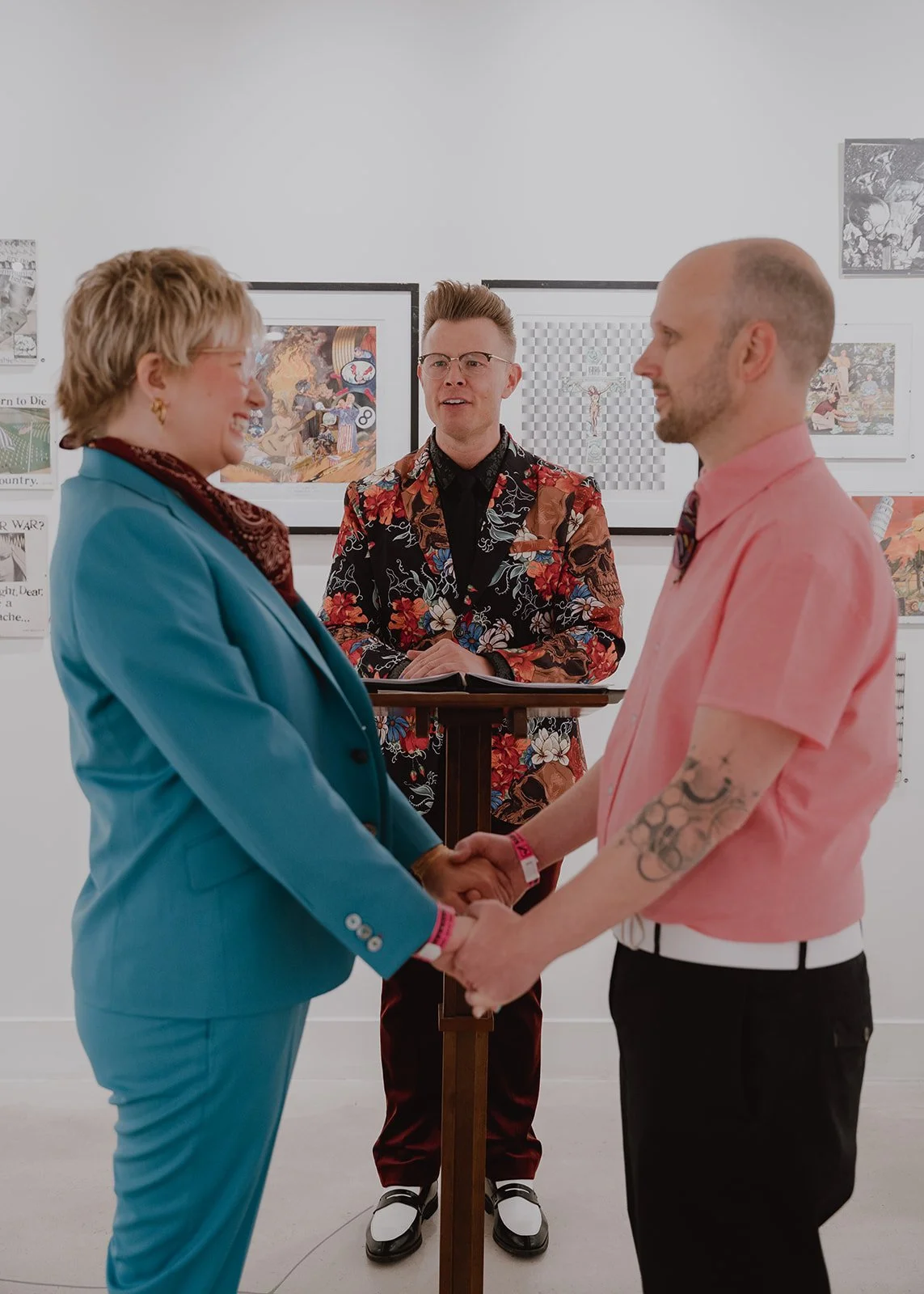 Couple holding hands during their Las Vegas wedding ceremony at The Punk Rock Museum in Las Vegas.