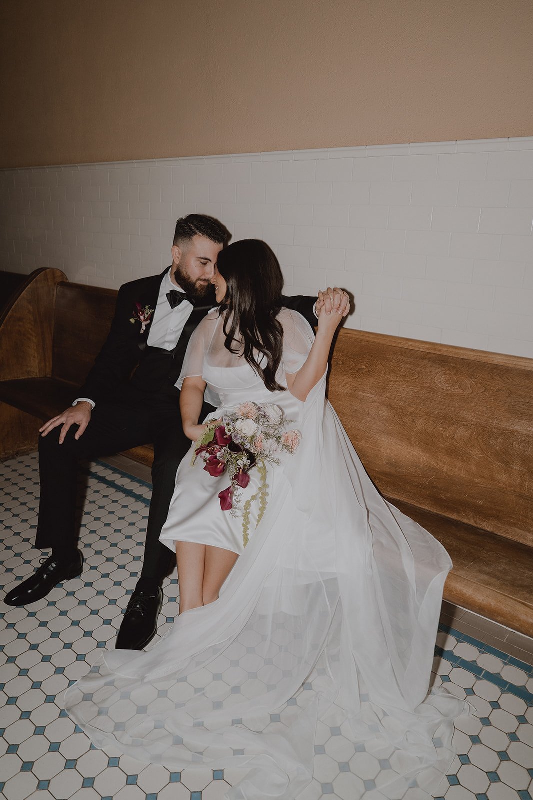 Couple sitting on a bench together at Old Orange County Courthouse.