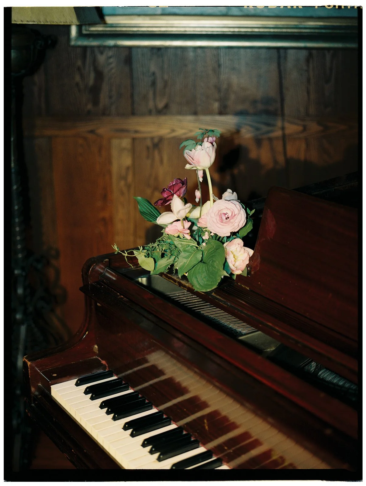 Florals on top of a piano.