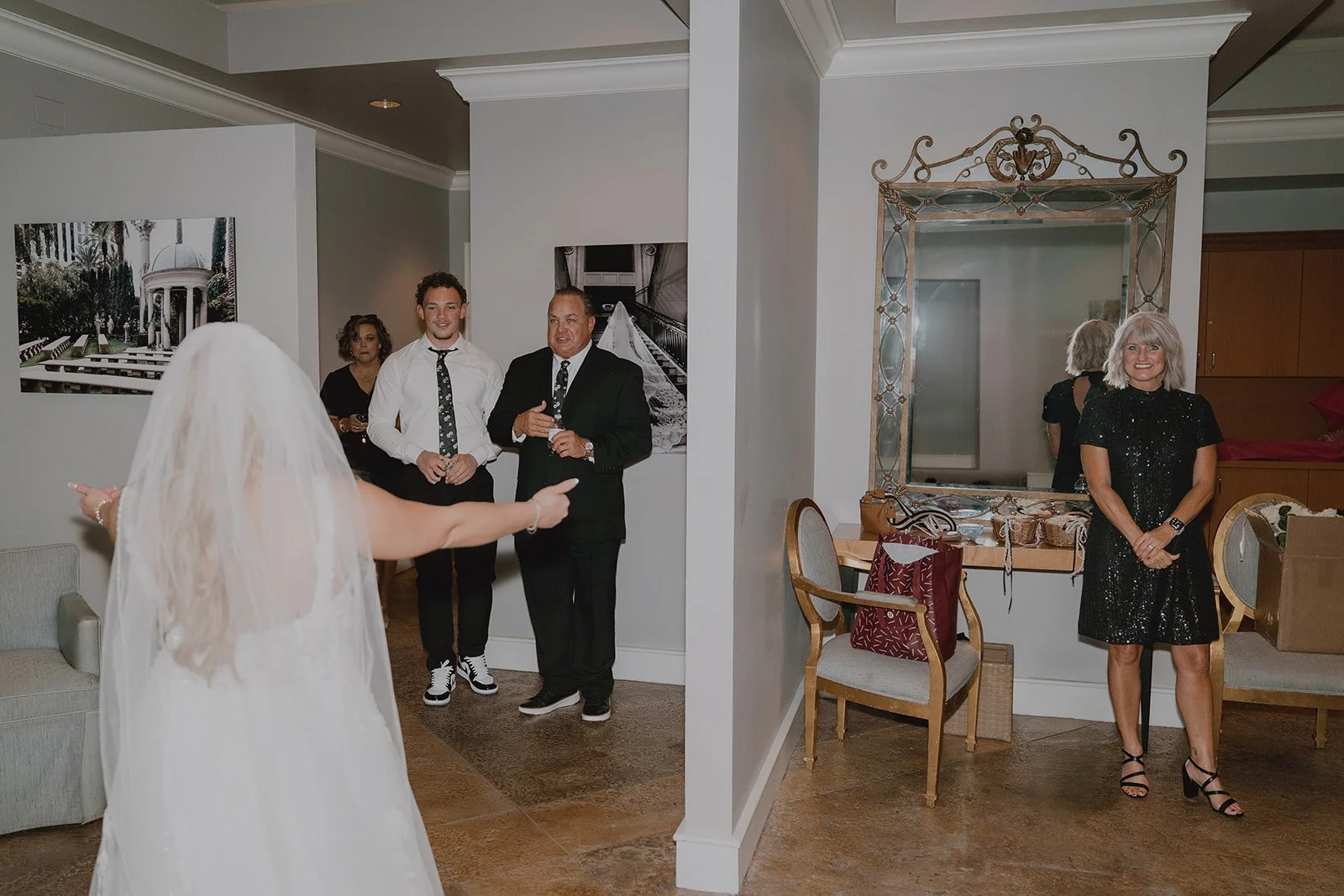 Bride entering the room as family reacts during getting ready at a Caesars Palace Venus Garden wedding.