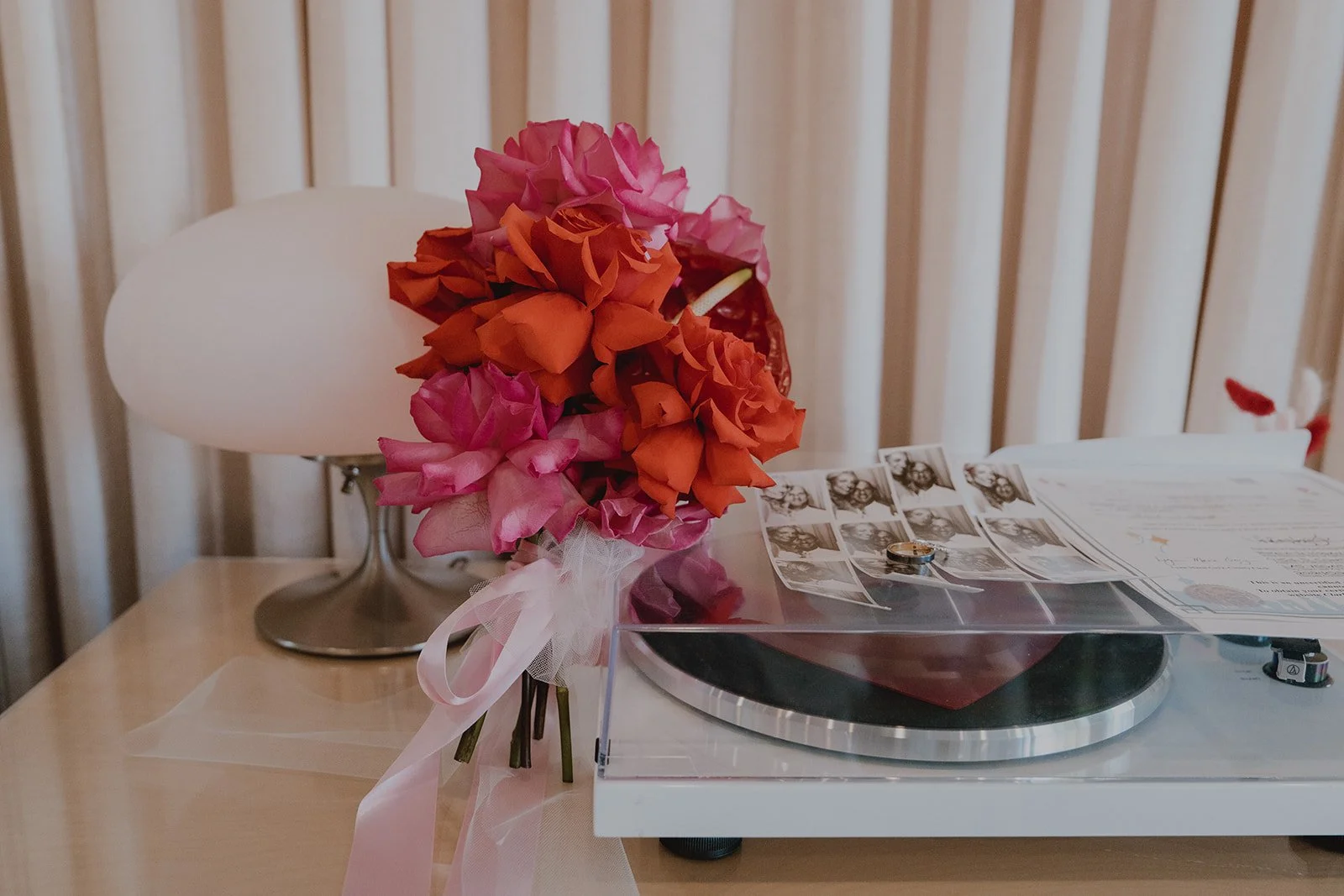 Bridal bouquet resting on a record player inside Sure Thing Chapel during a Las Vegas micro wedding.