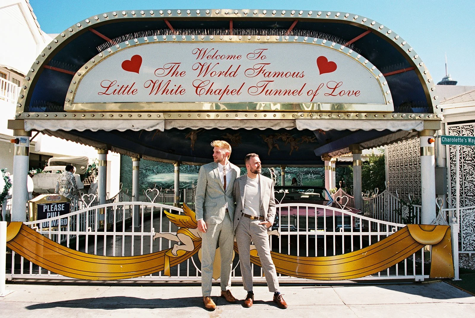 Couple posing outside of the Little White Wedding Chapels Tunnel of Love.