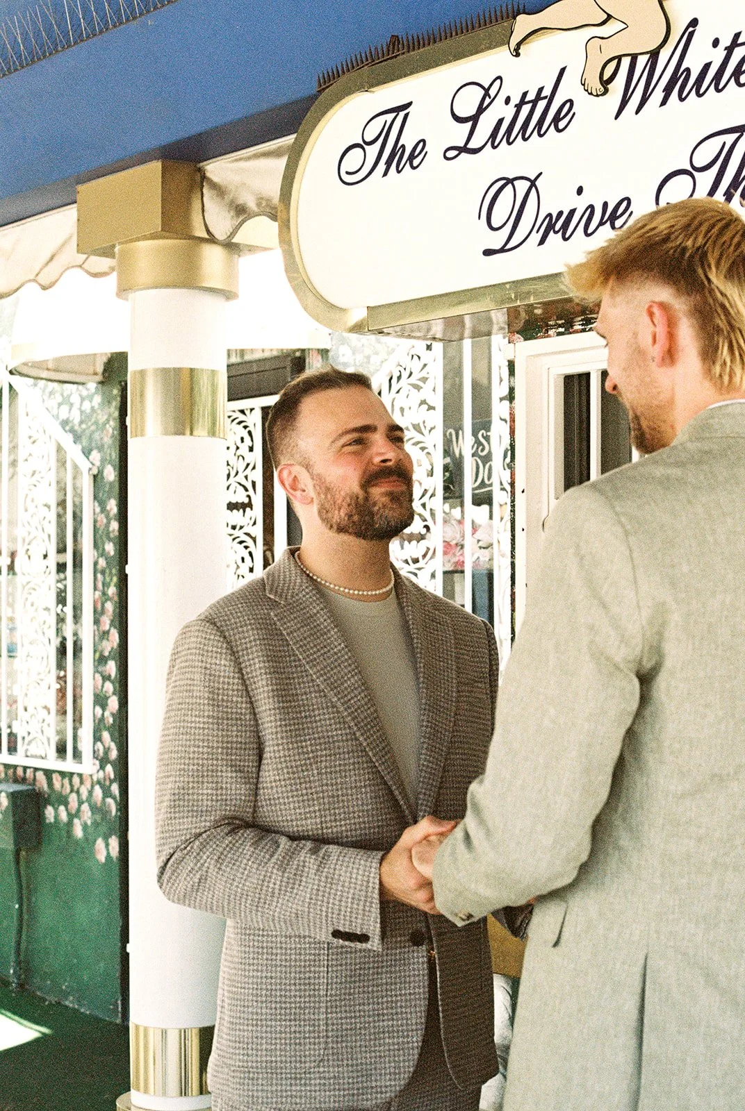 Groom smiling during his emotional Little White Chapel elopement in Las Vegas on 35mm film.