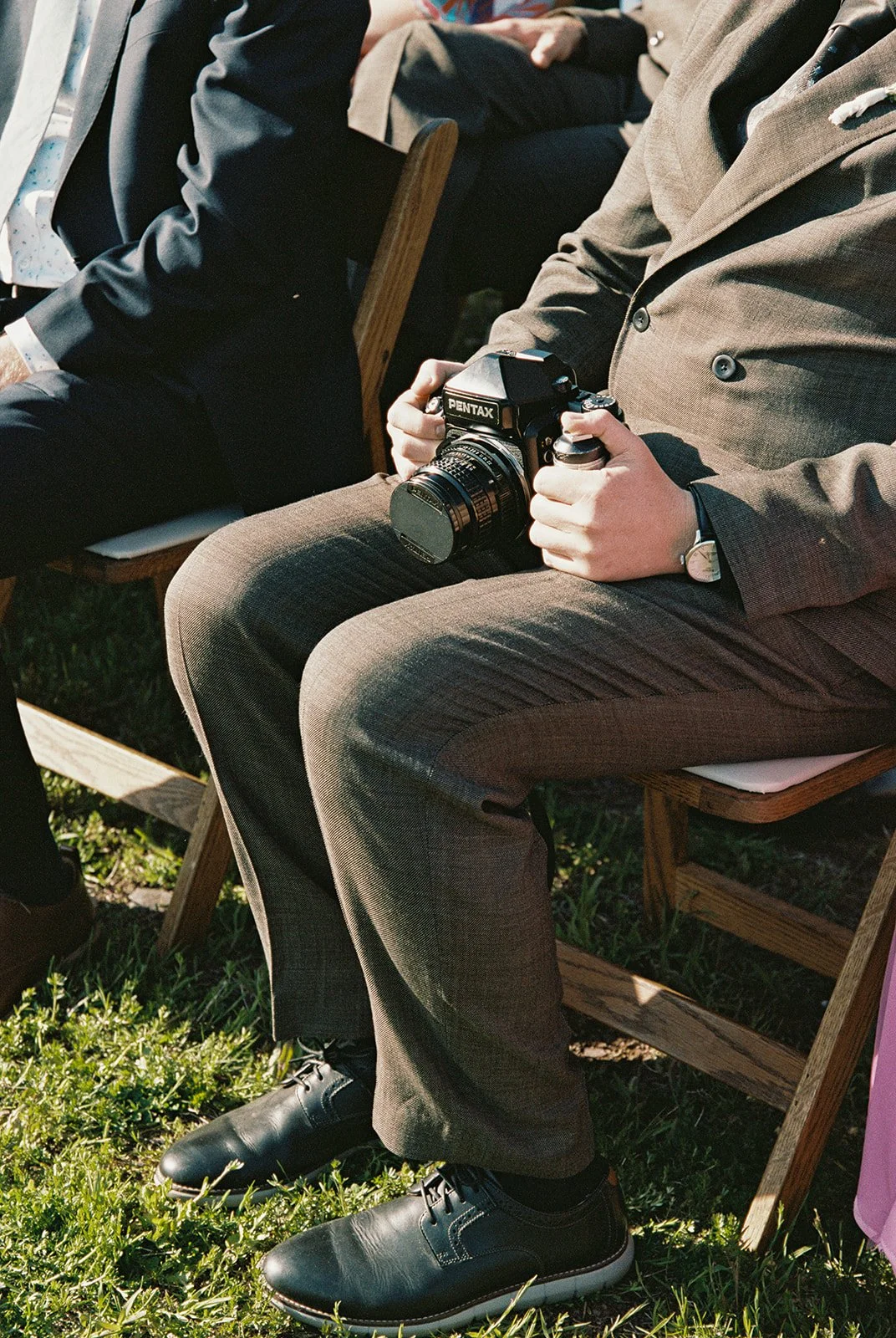 Close up photo of a guest holding a film camera.