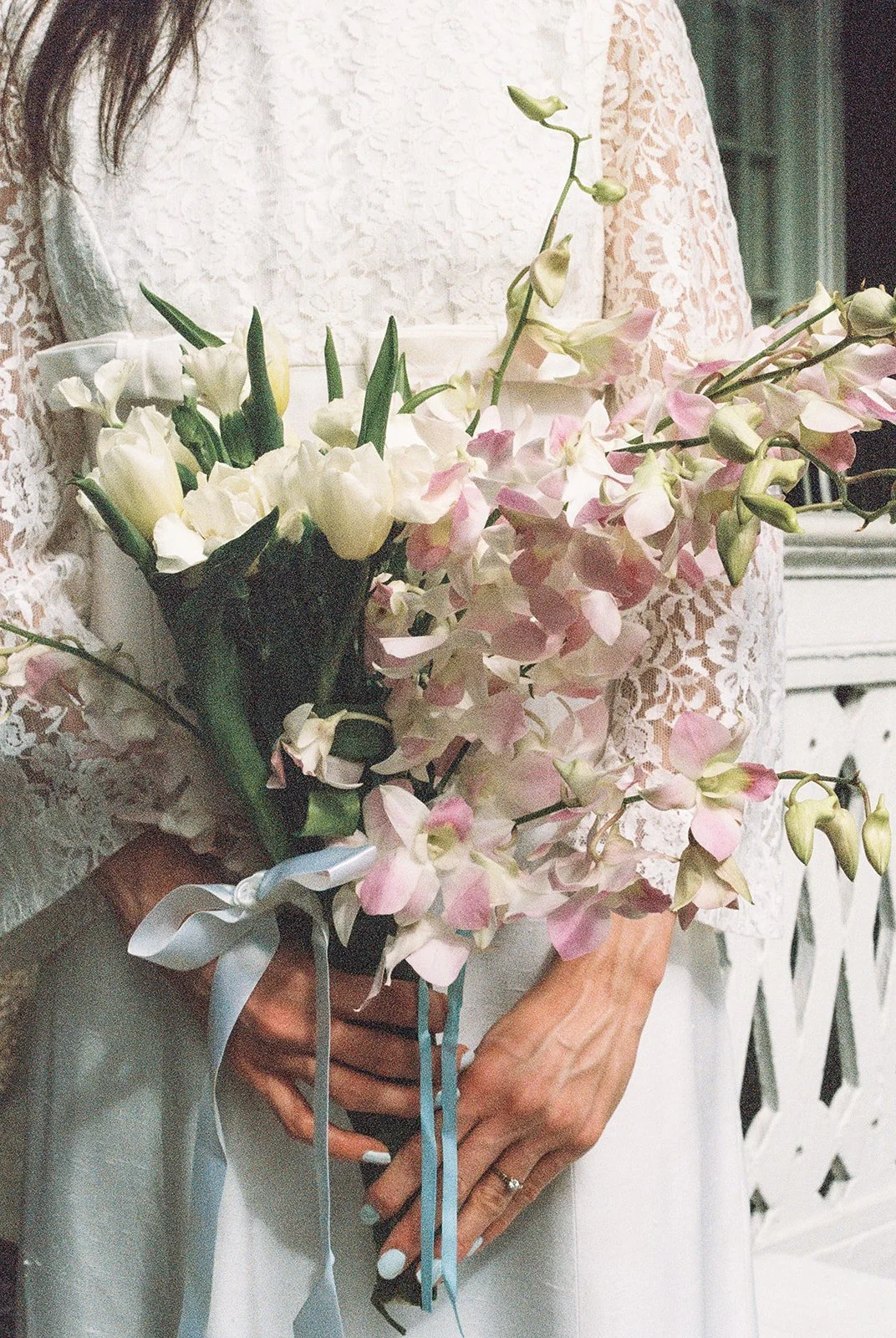 Close up shot of a bride holding her wedding bouquet on 35mm film.