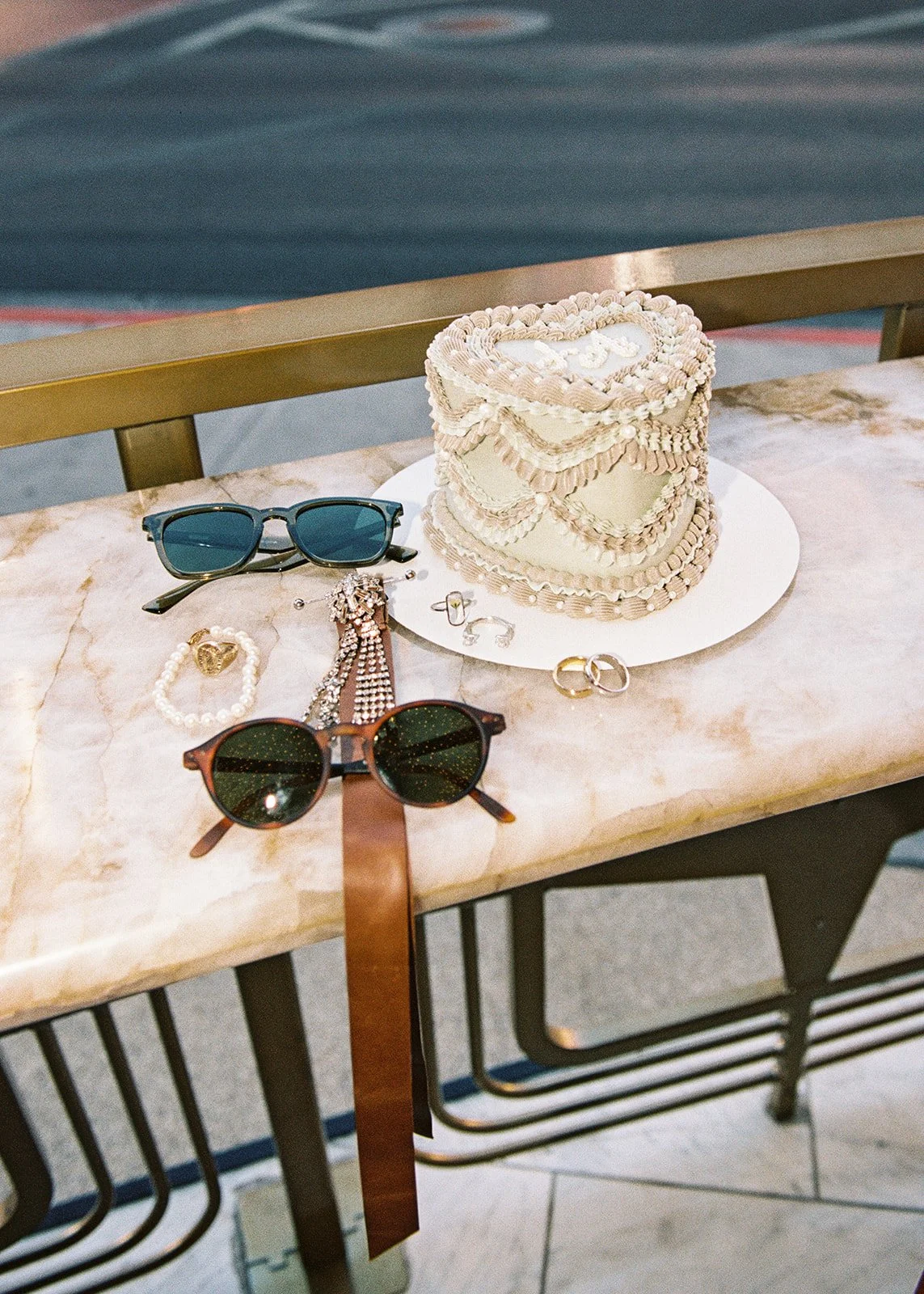 Vintage-inspired Las Vegas elopement cake by Winston Marie Cakes, sunglasses, and jewelry styled for detail shots.