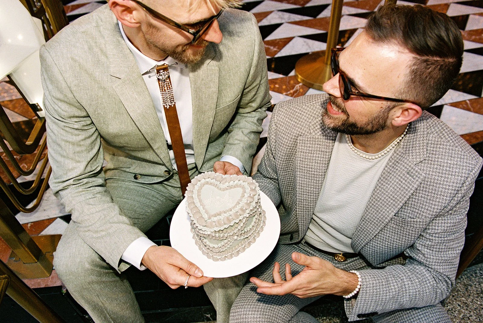 Couple holding their Las Vegas elopement cake on 35mm film by Winston Marie Cakes.