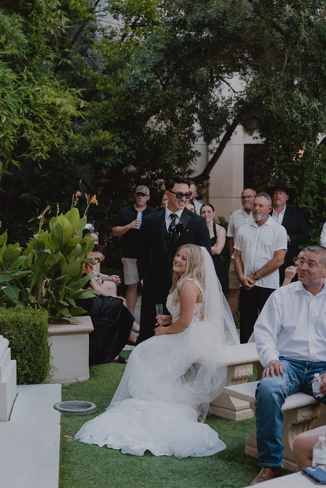 Bride and groom listening to speeches with their guests
