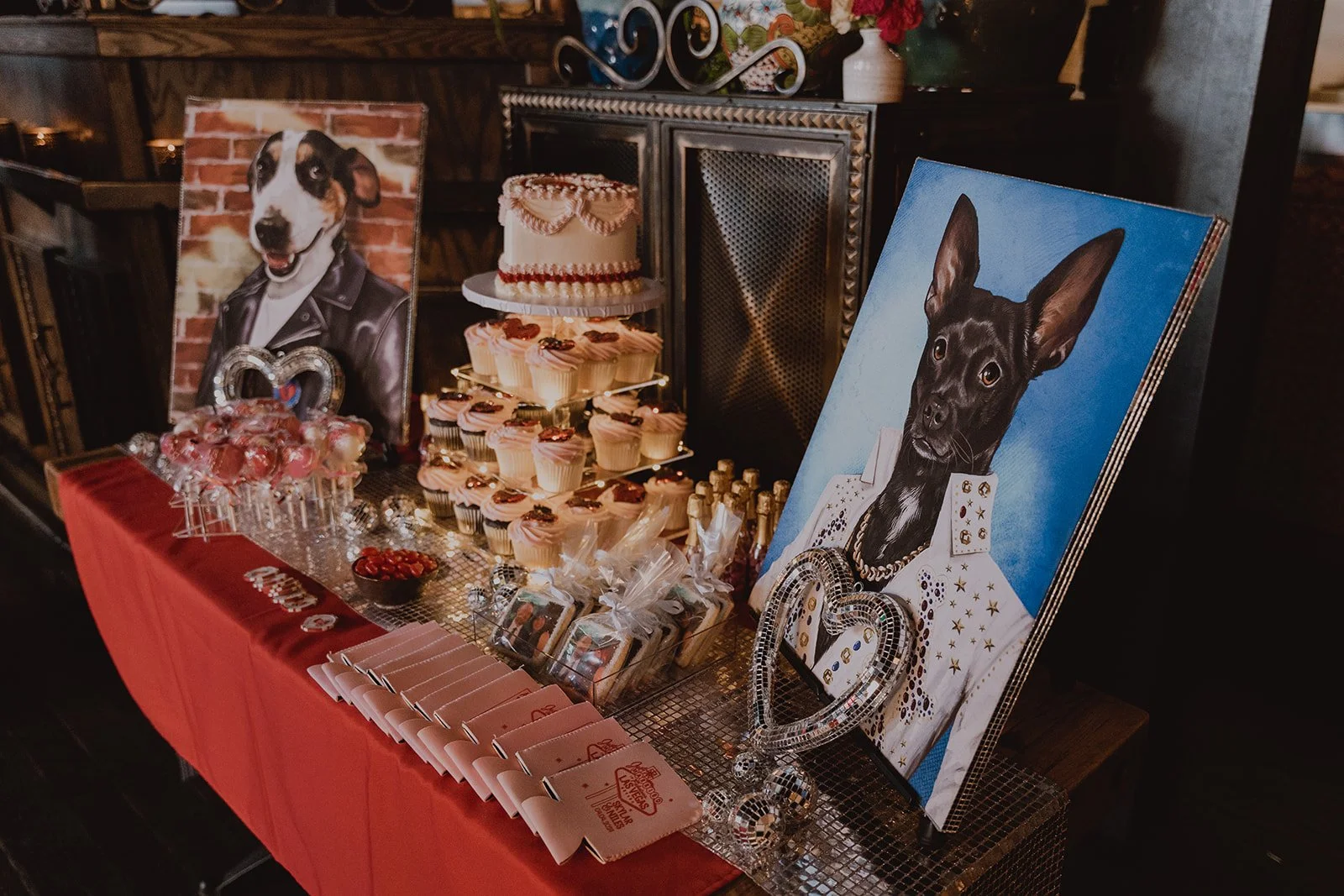 Wedding dessert table with cake, cupcakes, and dog portraits at La Mona Rosa Las Vegas reception.
