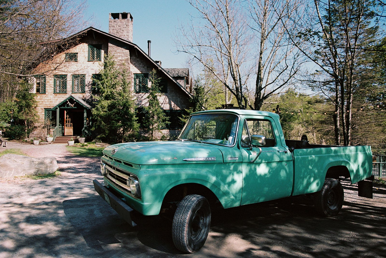 Film photo of a vintage green pickup truck parked outside Deer Mountain Inn in the Catskill Mountains.