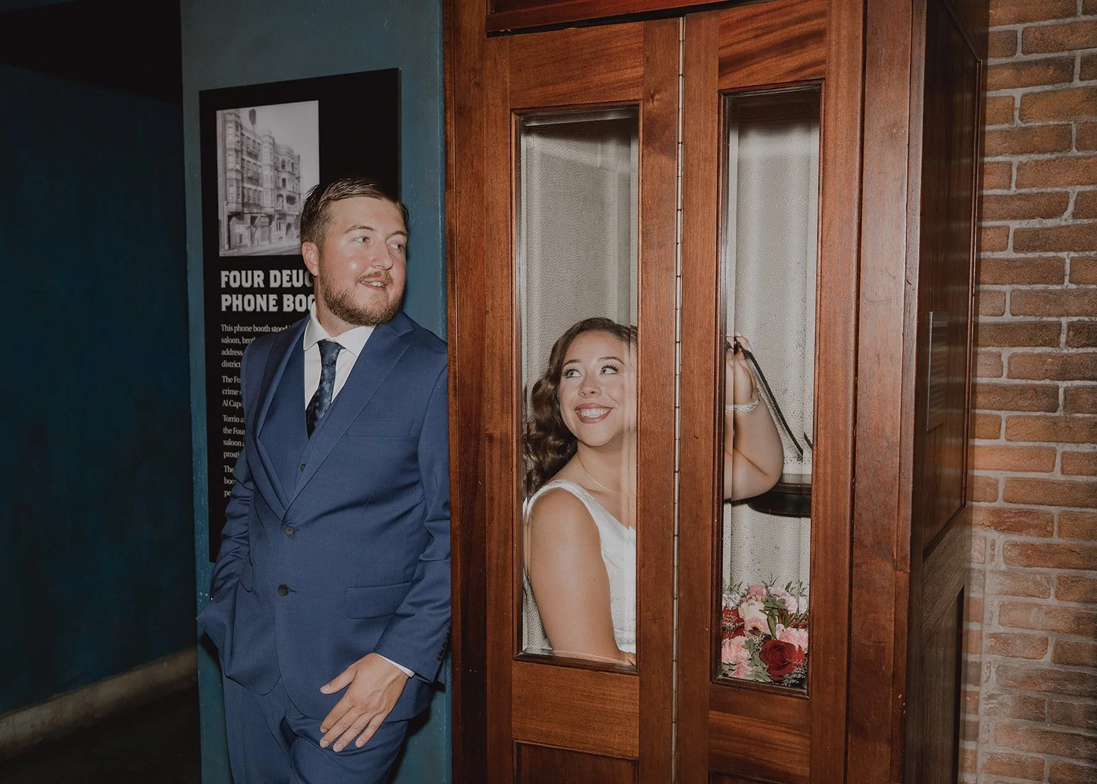 Bride and groom posing in a telephone booth at The Mob Museum in Las Vegas.