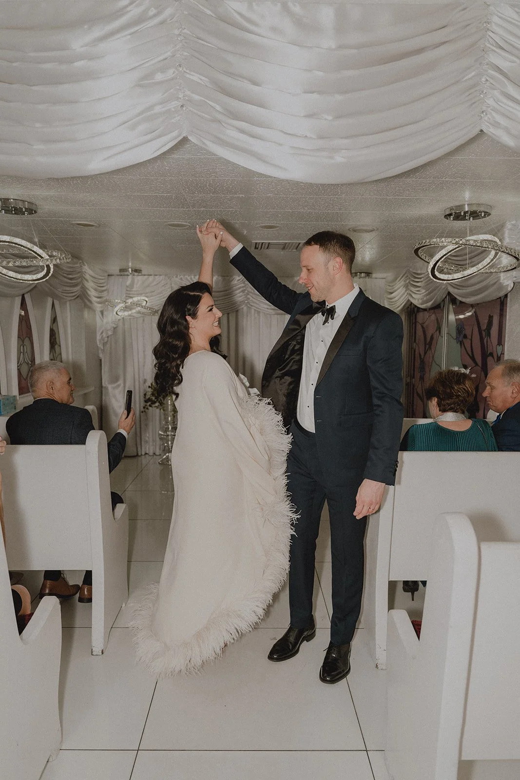 Groom twirling the bride after their Little White Chapel wedding in Las Vegas.