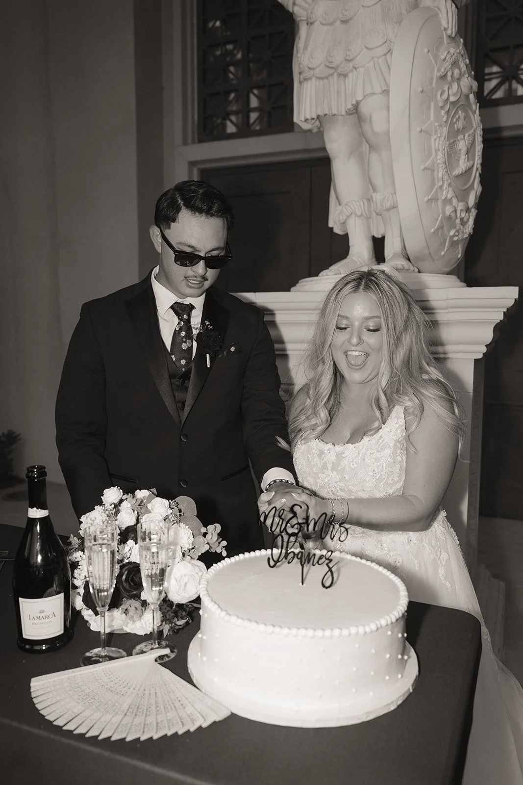 Bride and groom cutting their wedding cake during an intimate micro wedding in Las Vegas at Caesars Palace.