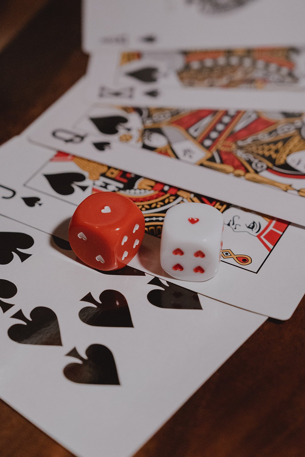 Close-up of playing cards and heart dice used as custom wedding games at a Velveteen Rabbit micro wedding reception in Las Vegas.