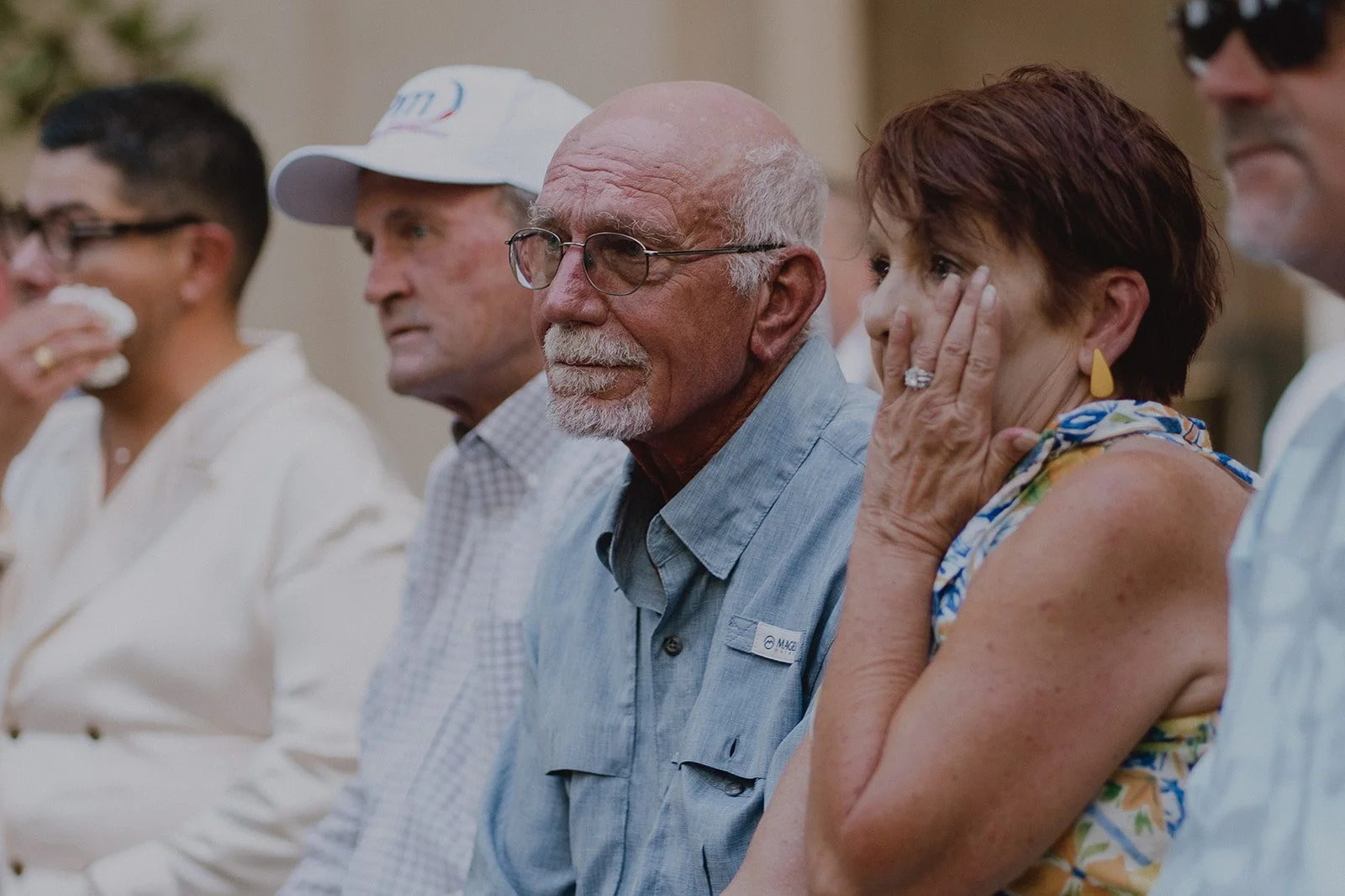 Guests getting emotional during an outdoor wedding ceremony during the vows