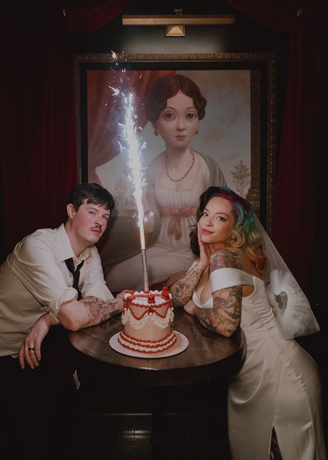 Bride and groom with wedding cake and sparkler at Cheapshot Las Vegas reception.