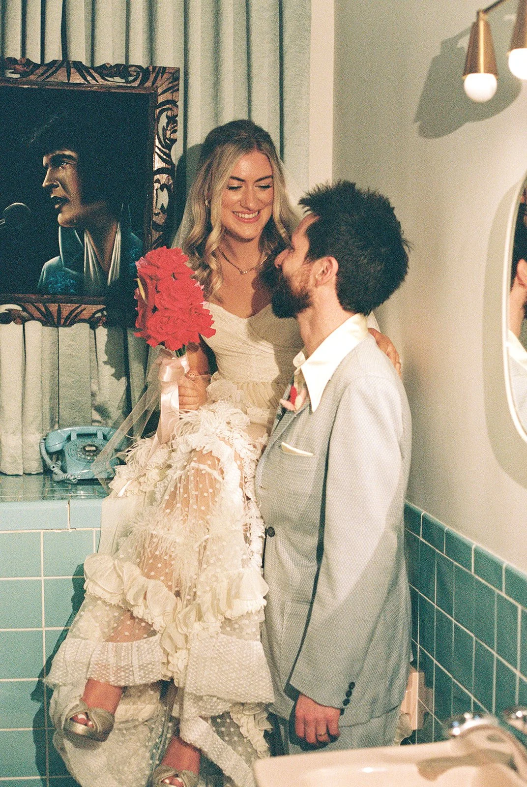 Couple posing in the bathroom at Sure Thing Chapel in Las Vegas on 35mm film.
