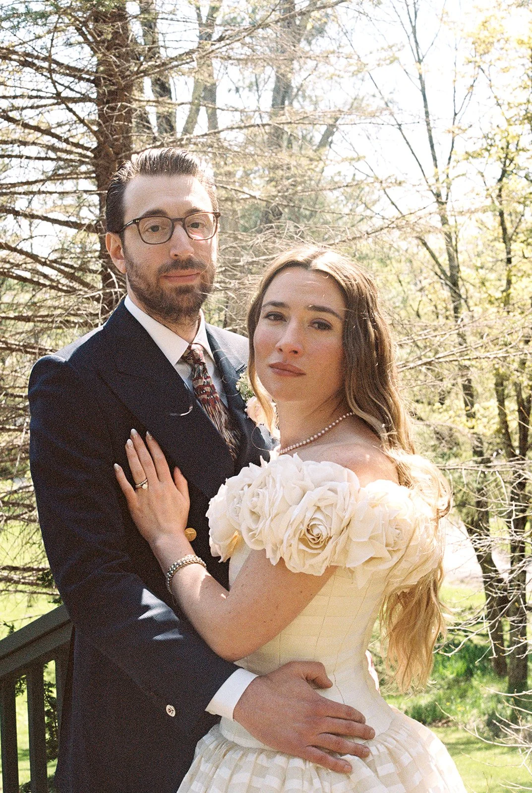 Close-up film wedding portrait of the bride and groom embracing outdoors at Deer Mountain Inn.
