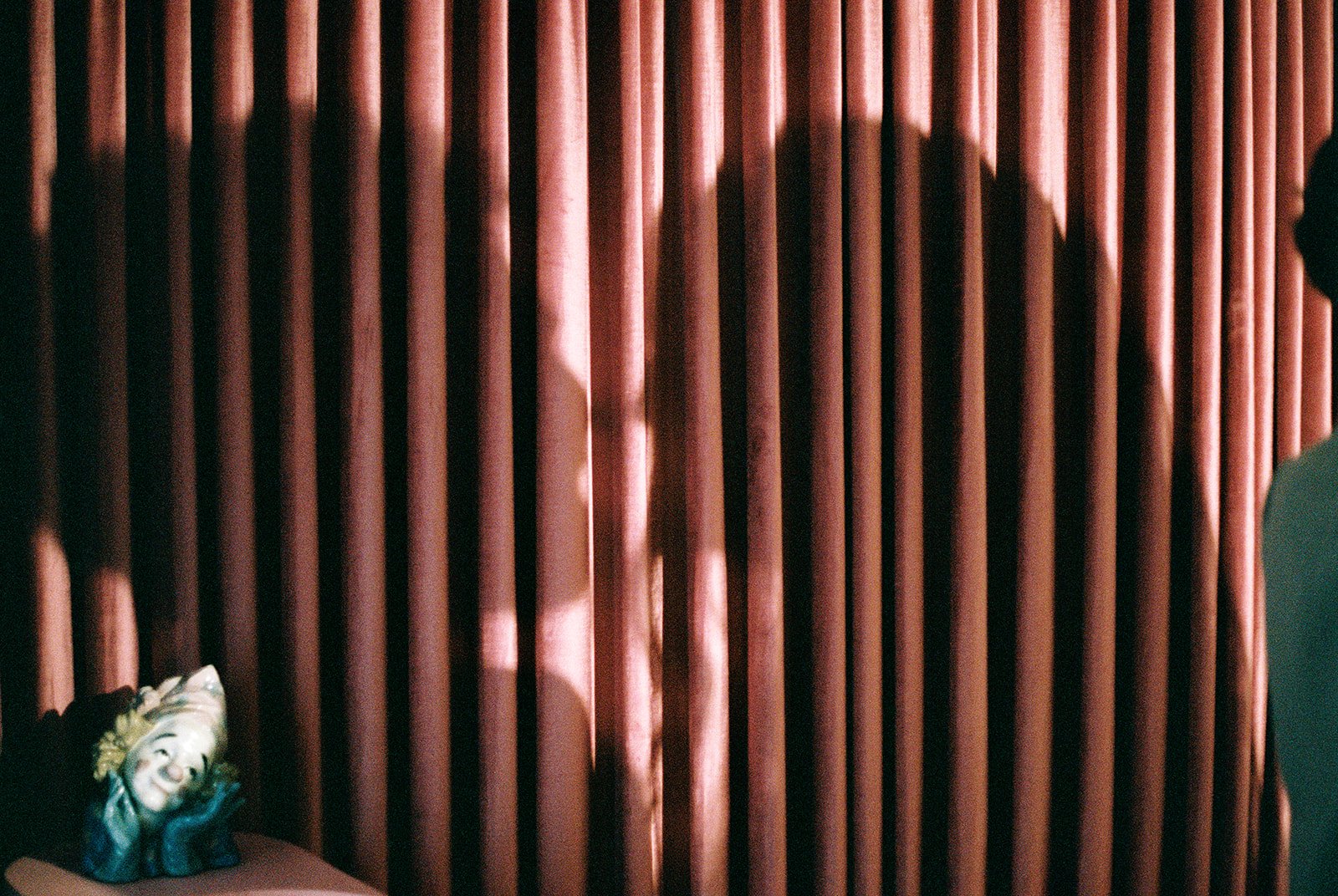 Photo capturing the couples shadows on pink curtains at Sure Tahing Chapel in Las Vegas on 35mm film.