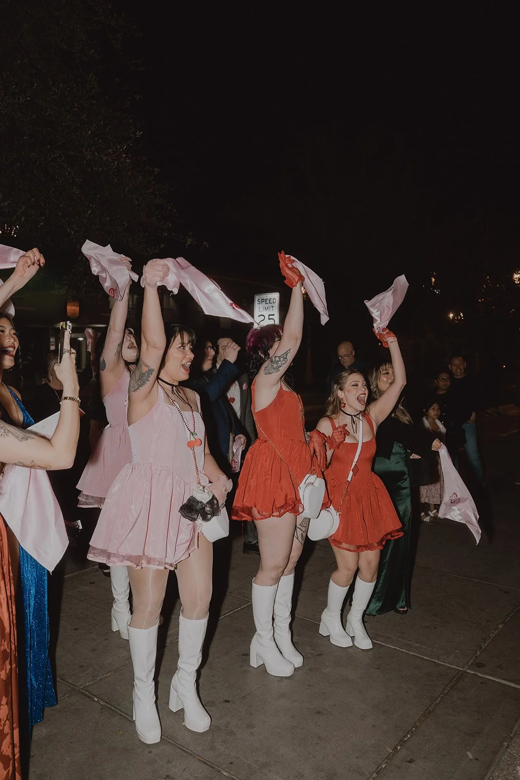 Wedding guests waving handkerchiefs during a second line wedding parade on Fremont Street.
