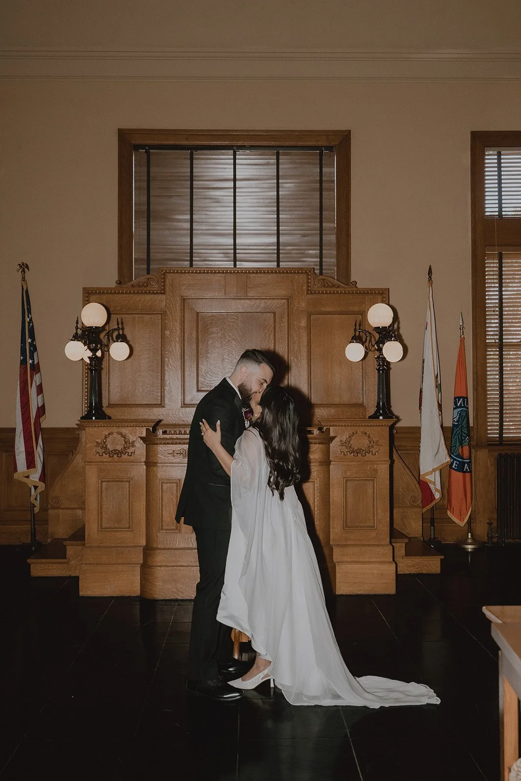 Couple kissing at the altar during their Old Orange County Courthouse wedding.