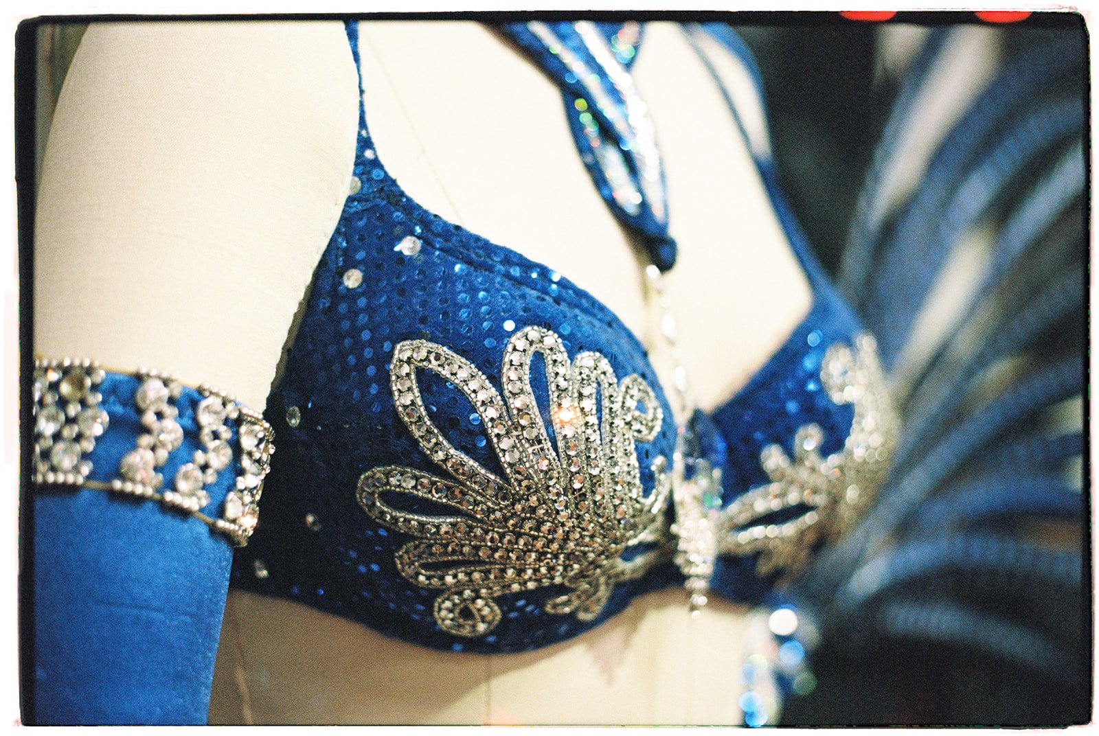 Detailed close-up of a blue rhinestoned Las Vegas showgirl costume top photographed on film.