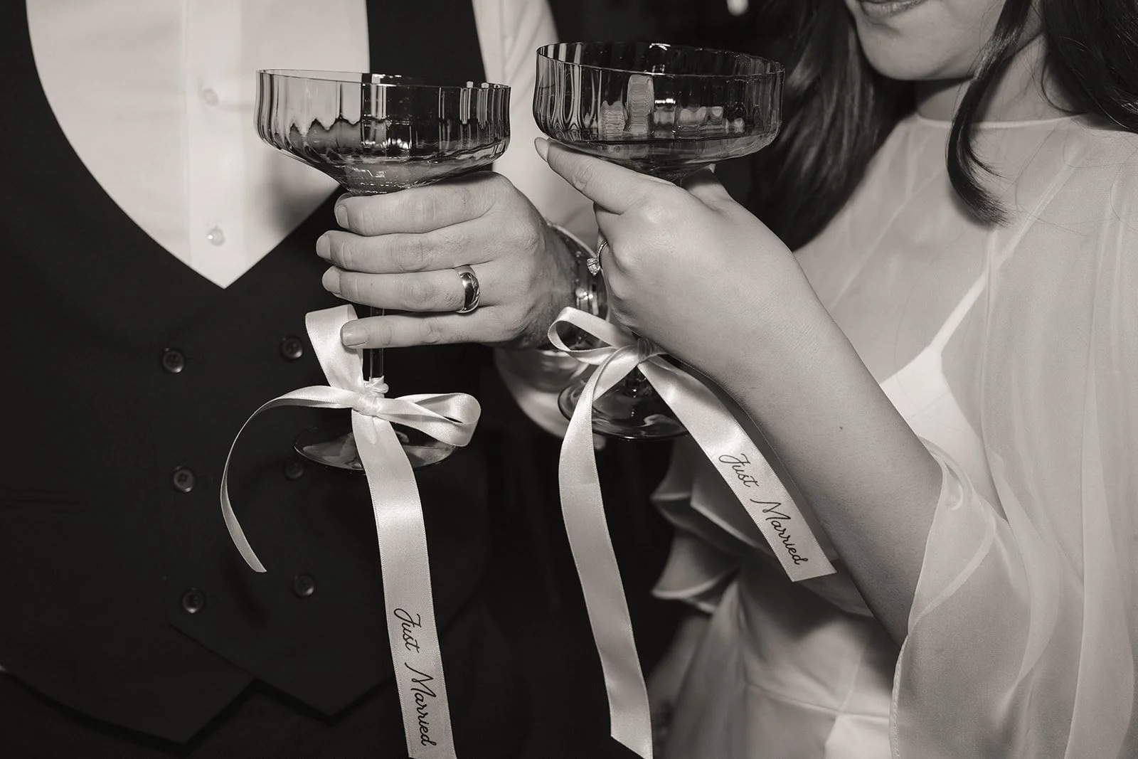 Black and white photo of a bride and groom having drinks during their Orange County micro wedding reception brunch.