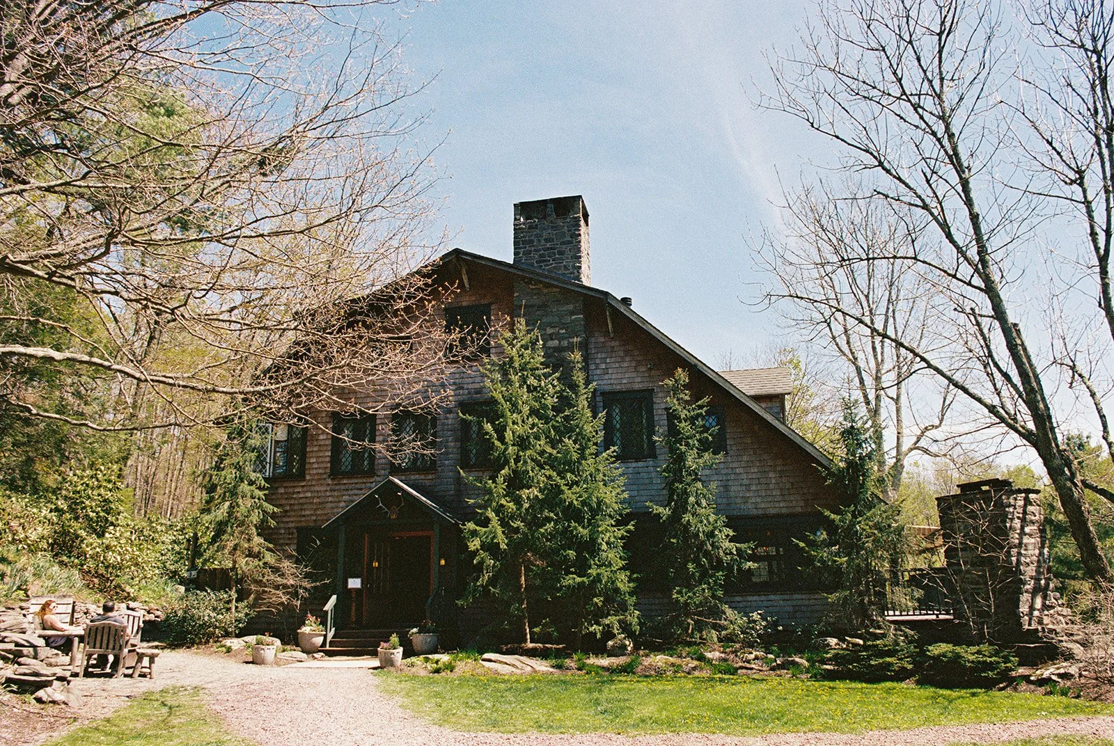Film photo of the rustic Deer Mountain Inn exterior surrounded by trees in the Catskill Mountains.