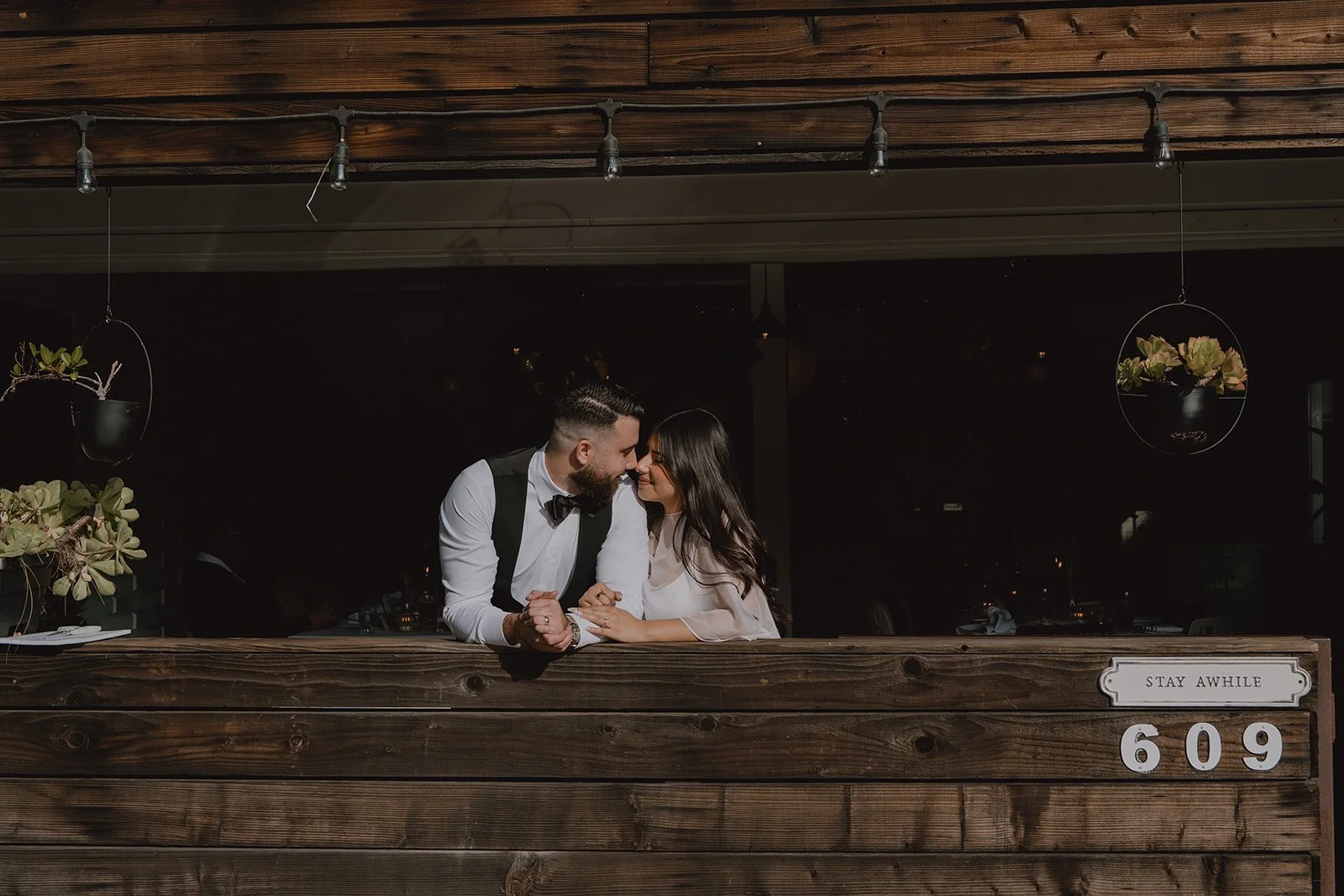 Bride and groom posing for a photo at Benchmark Restaurant in Orange County.