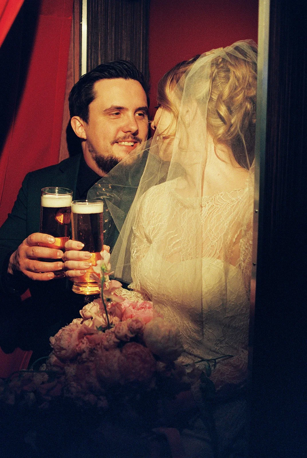 Couple having beers inside a photobooth at The Silver Stamp in Las Vegas on 35mm film.