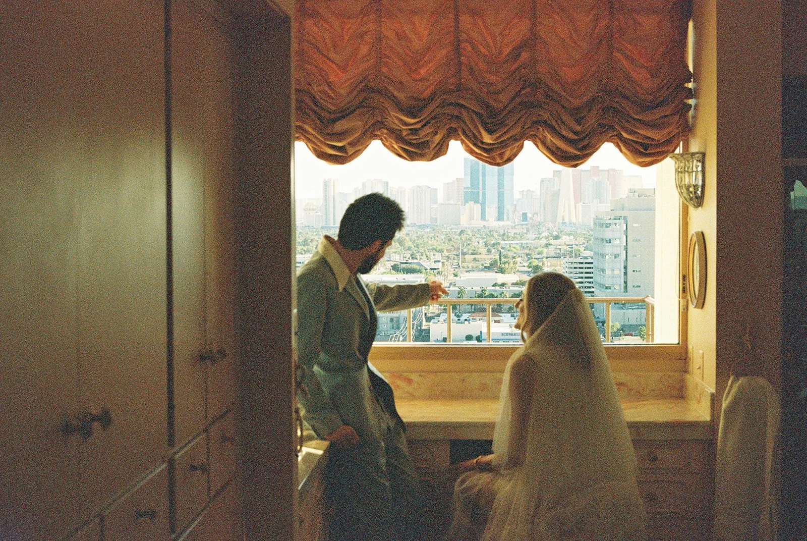Couple admiring the views from the bathroom at the Jackie Gaughan Suite at El Cortez Hotel in Las Vegas.