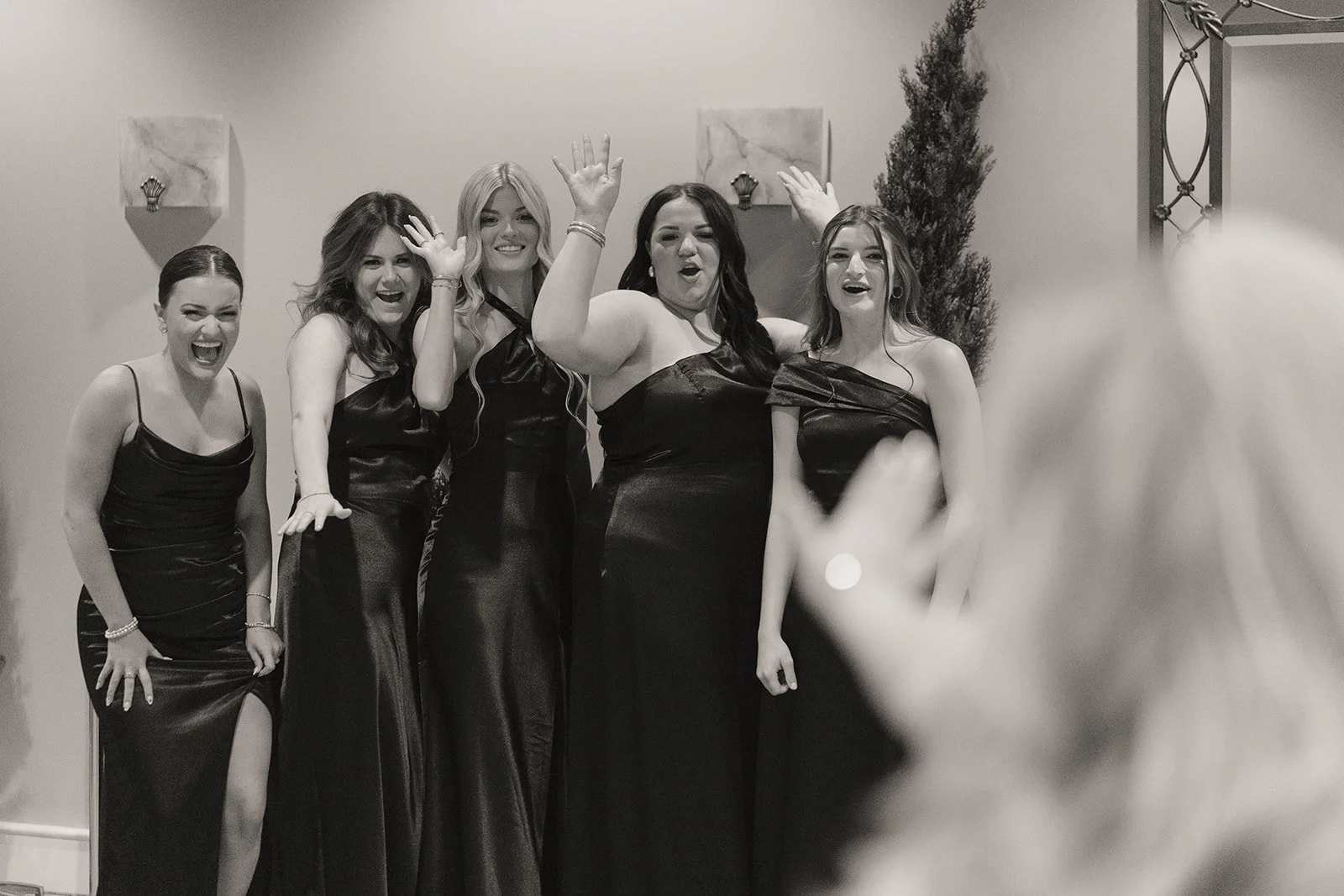 Bridesmaids reacting joyfully as the bride reveals her dress before a Caesars Palace Venus Garden wedding.