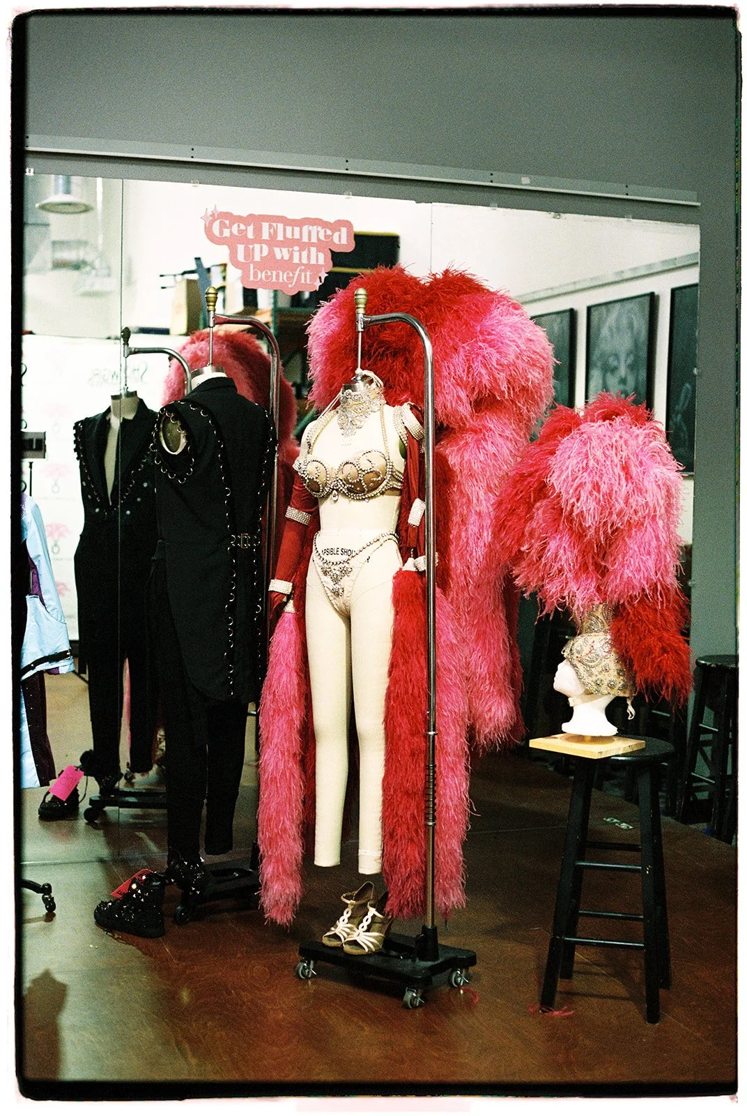 Vintage Las Vegas showgirl costume displayed on a mannequin with feathered details inside the Showgirl Bootcamp wardrobe space.